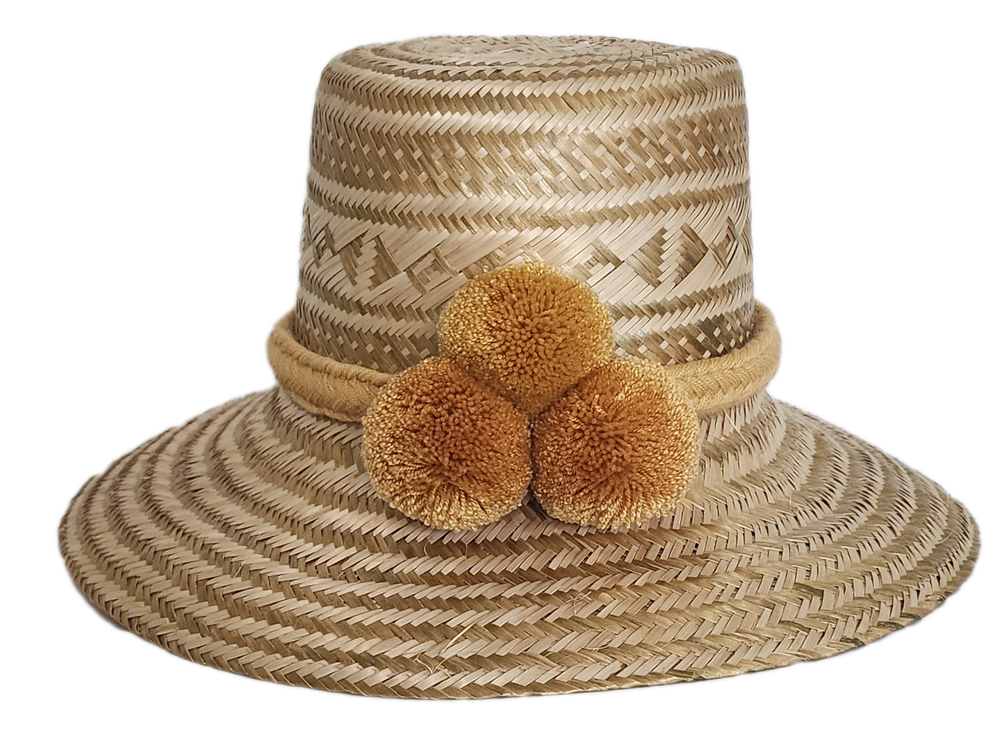 Boho Wayuu straw hat in natural beige tones with intricate geometric patterns, a soft mustard pom-pom trio, and braided band — a handcrafted, bohemian-style accessory with artisan elegance.