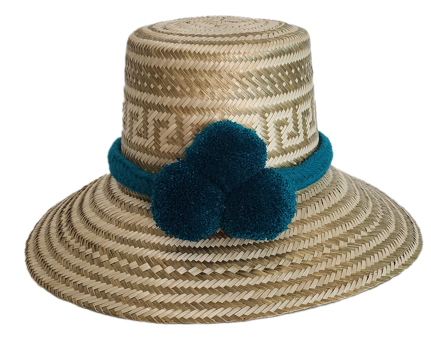 Boho Wayuu straw hat in natural tones with subtle gold accents, adorned with teal pom-poms and a matching braided band — a handcrafted bohemian fashion accessory with colorful artisan charm.