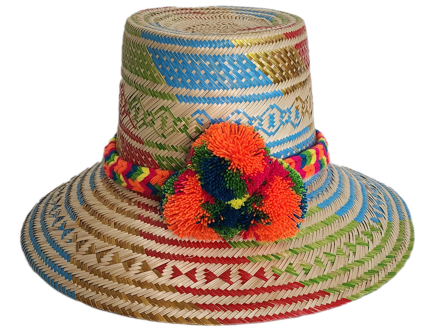 Boho Wayuu straw hat featuring colorful artisan weave in blue, red, green, and gold, with a rainbow braided band and bright orange pom-poms — a handcrafted bohemian accessory full of vibrant summer flair.