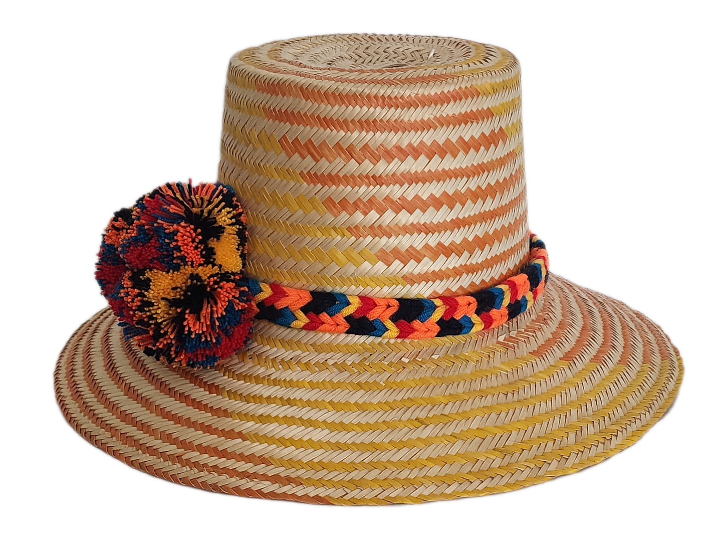 Boho Wayuu straw hat with warm orange and yellow woven patterns, a colorful braided band, and bold multicolor pom-poms — a vibrant, handcrafted bohemian accessory full of artisan detail.