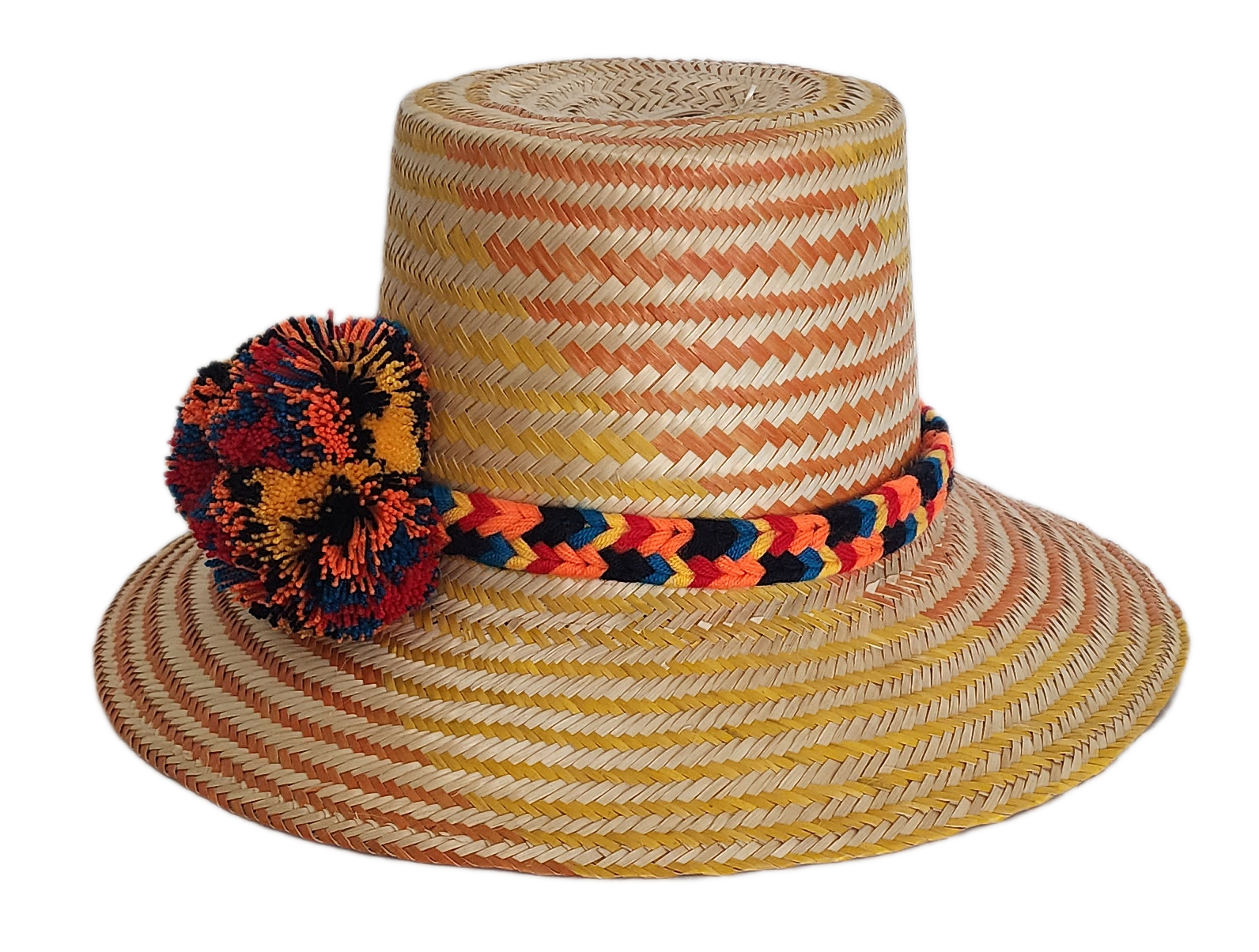 Boho Wayuu straw hat with warm orange and yellow woven patterns, a colorful braided band, and bold multicolor pom-poms — a vibrant, handcrafted bohemian accessory full of artisan detail.