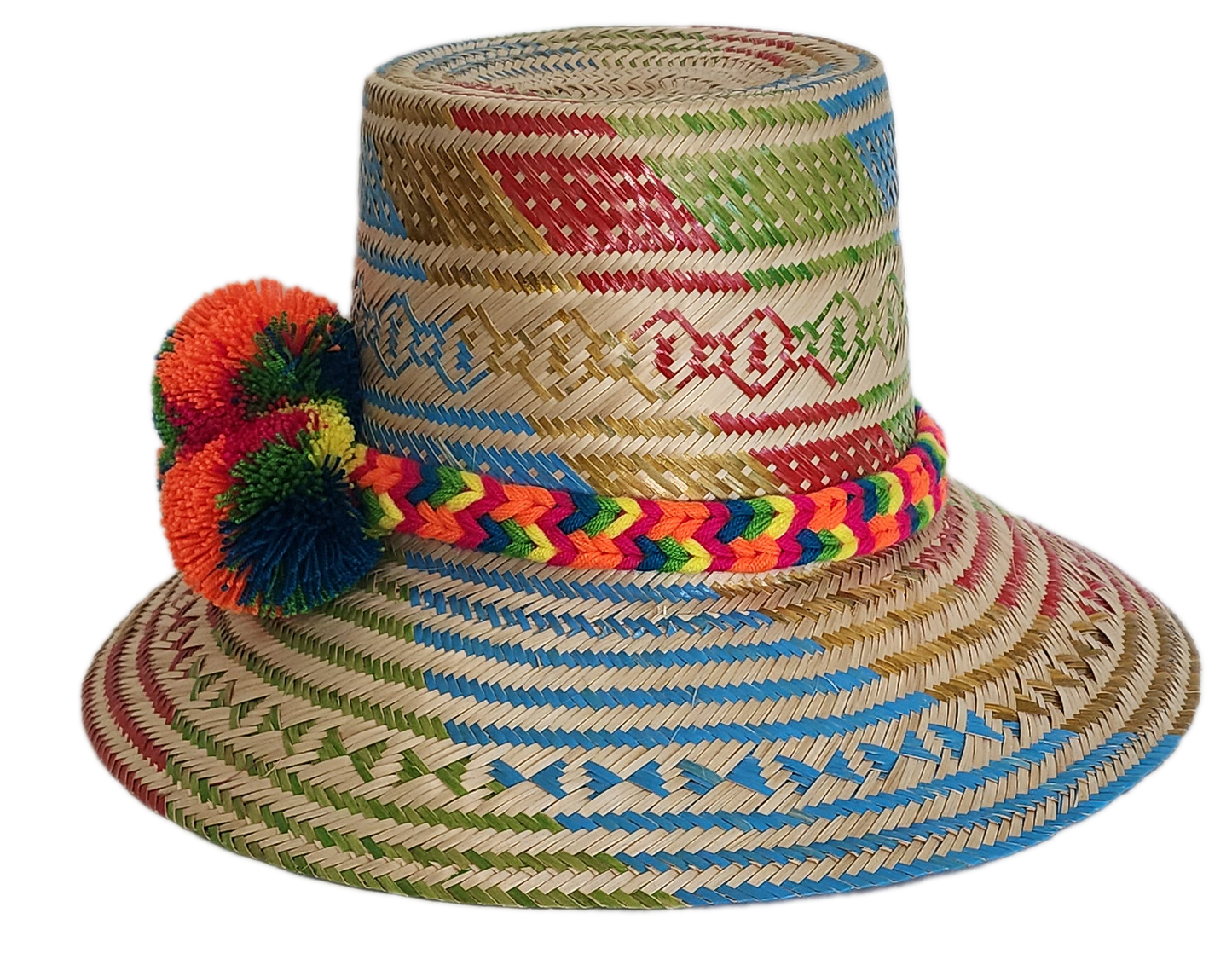 Boho Wayuu straw hat featuring colorful artisan weave in blue, red, green, and gold, with a rainbow braided band and bright orange pom-poms — a handcrafted bohemian accessory full of vibrant summer flair.