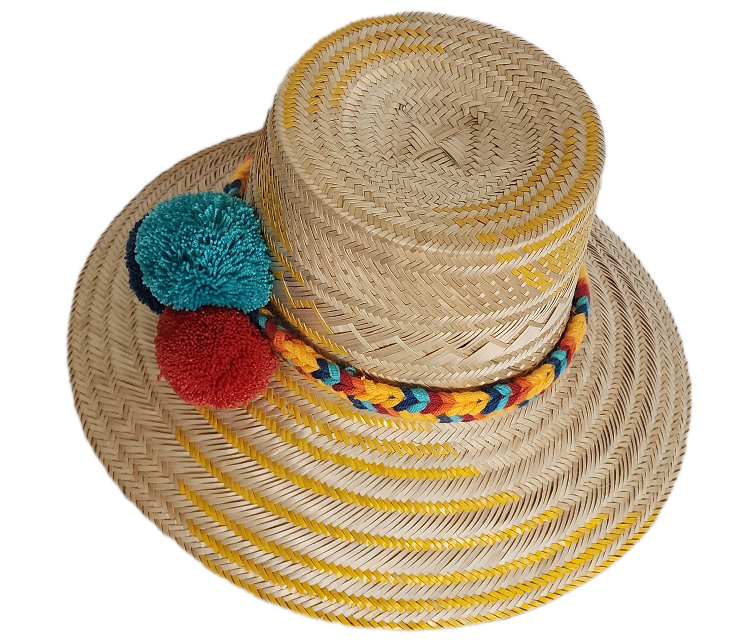 Boho Wayuu straw hat with yellow zigzag woven accents, a vibrant braided band, and colorful pom-poms in teal, red, and navy — a handcrafted bohemian accessory perfect for sunny days.