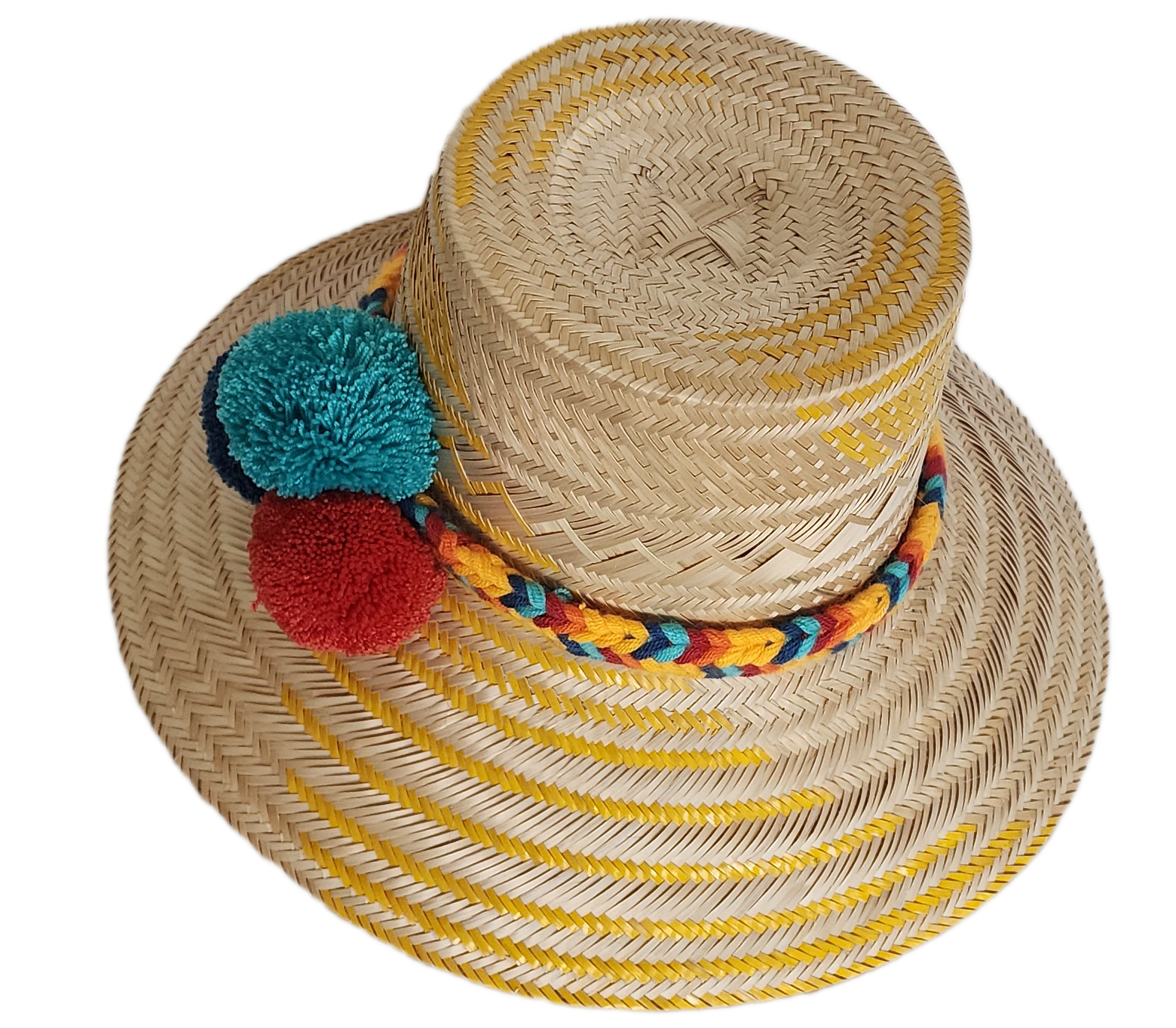 Boho Wayuu straw hat with yellow zigzag woven accents, a vibrant braided band, and colorful pom-poms in teal, red, and navy — a handcrafted bohemian accessory perfect for sunny days.