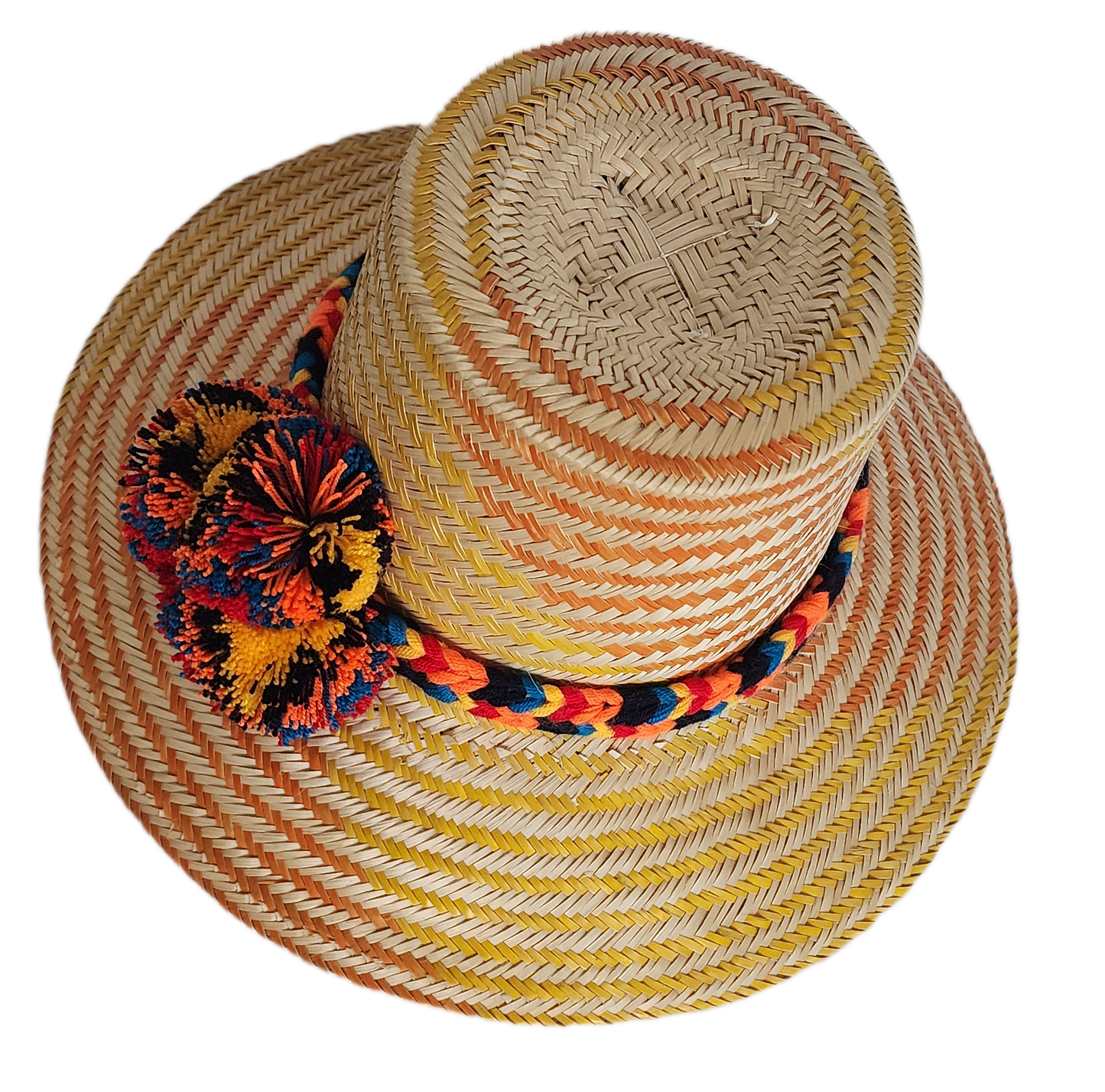Boho Wayuu straw hat with warm orange and yellow woven patterns, a colorful braided band, and bold multicolor pom-poms — a vibrant, handcrafted bohemian accessory full of artisan detail.