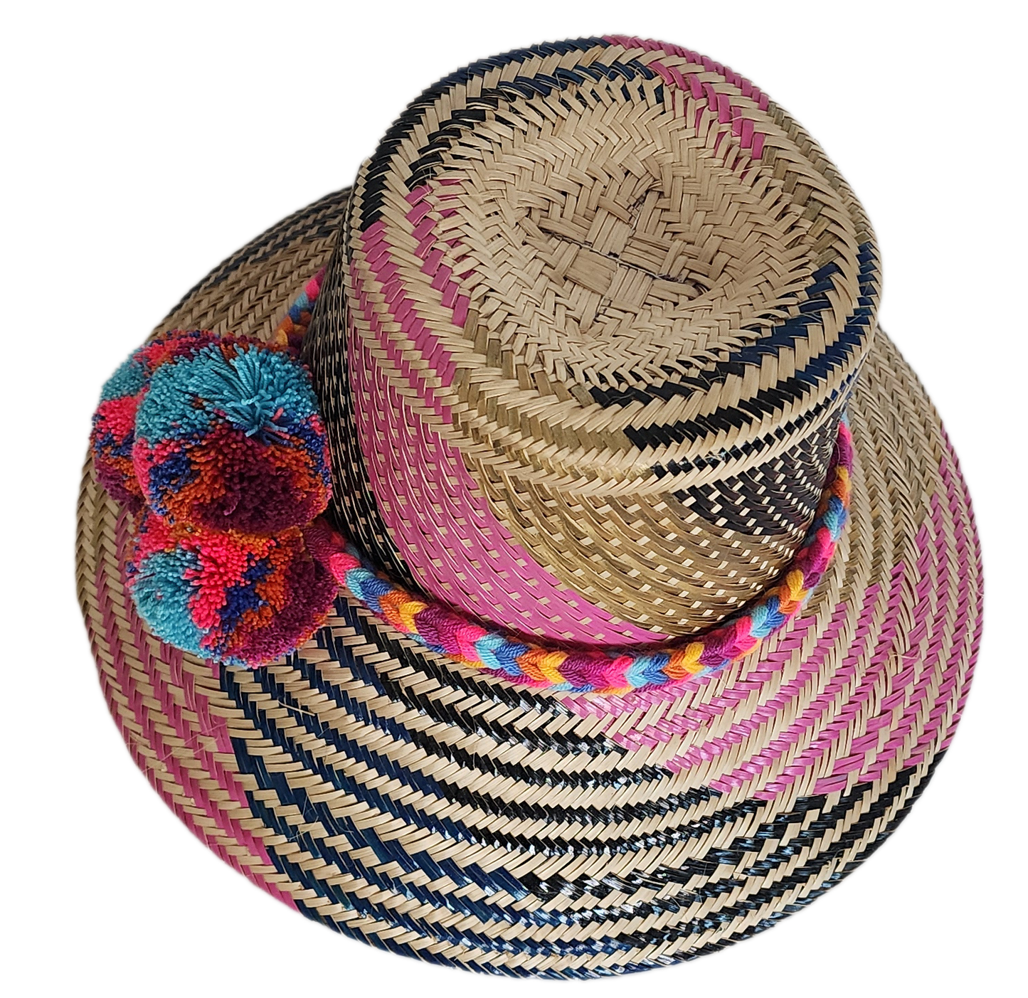 Boho Wayuu straw hat with vibrant pink, navy, and natural woven design, a multicolor braided band, and playful pom-poms in turquoise, red, and orange — a colorful, handcrafted bohemian summer accessory.
