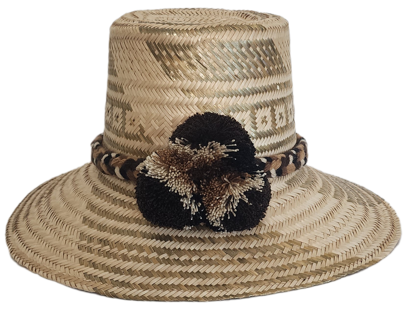 A stylish, handmade straw hat featuring intricate light and dark straw geometric patterns and a unique band with black, brown, and cream twisted elements and a black and brown pompom.