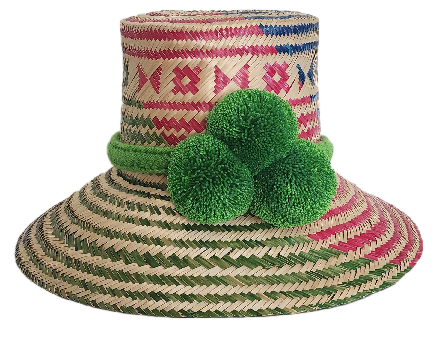A colorful, handmade straw hat with red, blue, and green geometric patterns and a vibrant green pompom band with three fluffy pompoms.