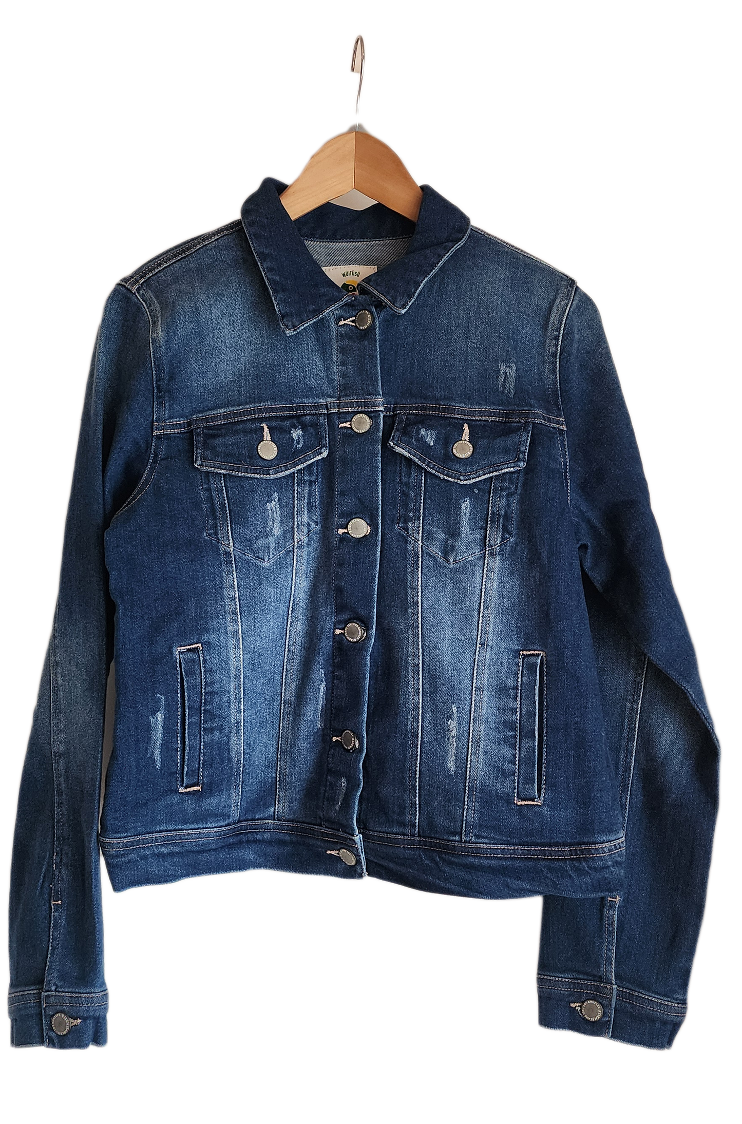 "Artisan-made denim jacket with vibrant, Wayuu-inspired punch needle embroidery on the back, showcasing unique craftsmanship.