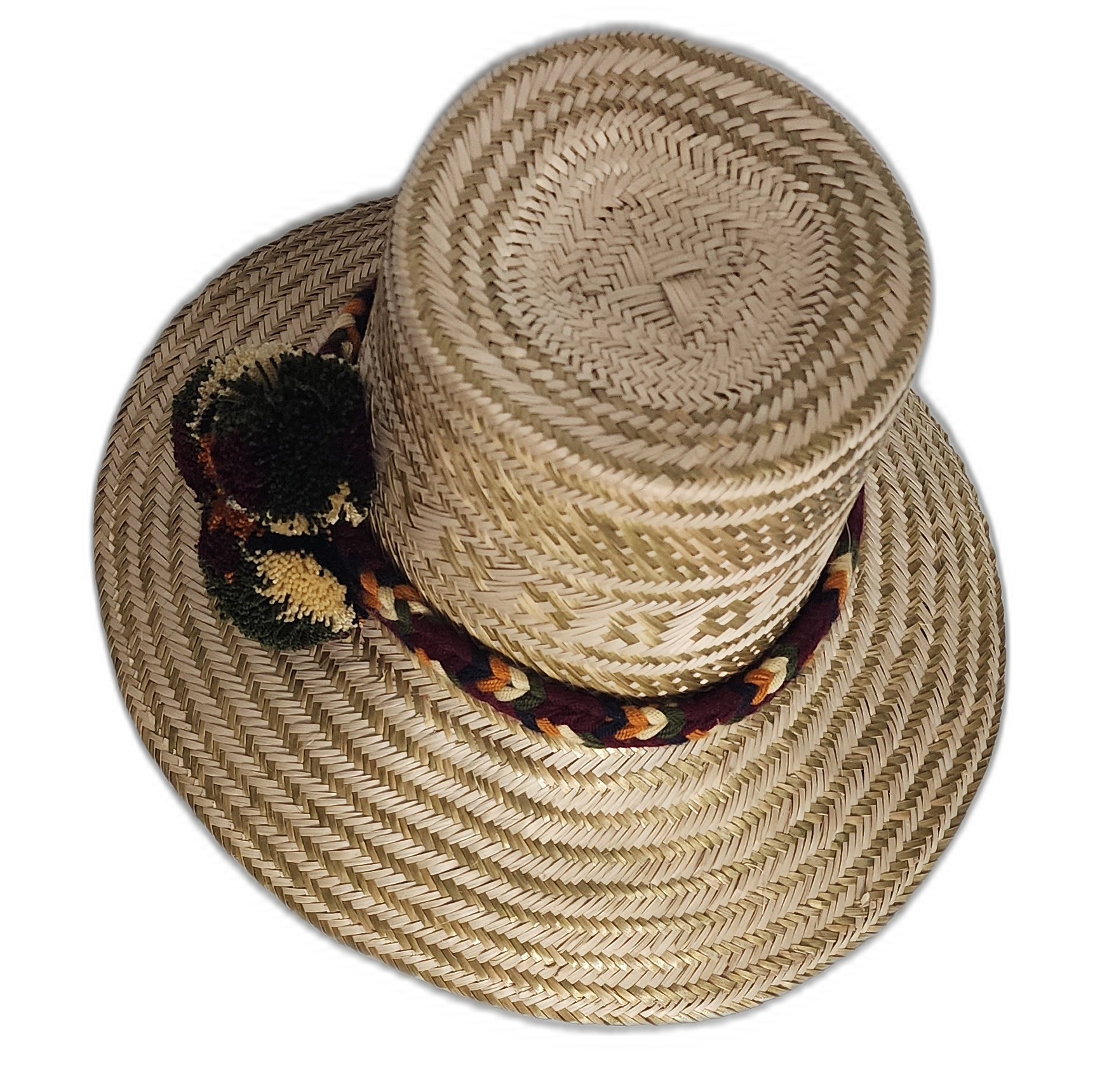 Artisan Wayuu hat featuring woven band and burgundy-green pompoms
Cultural Wayuu straw hat with dark pompom accents and geometric design
