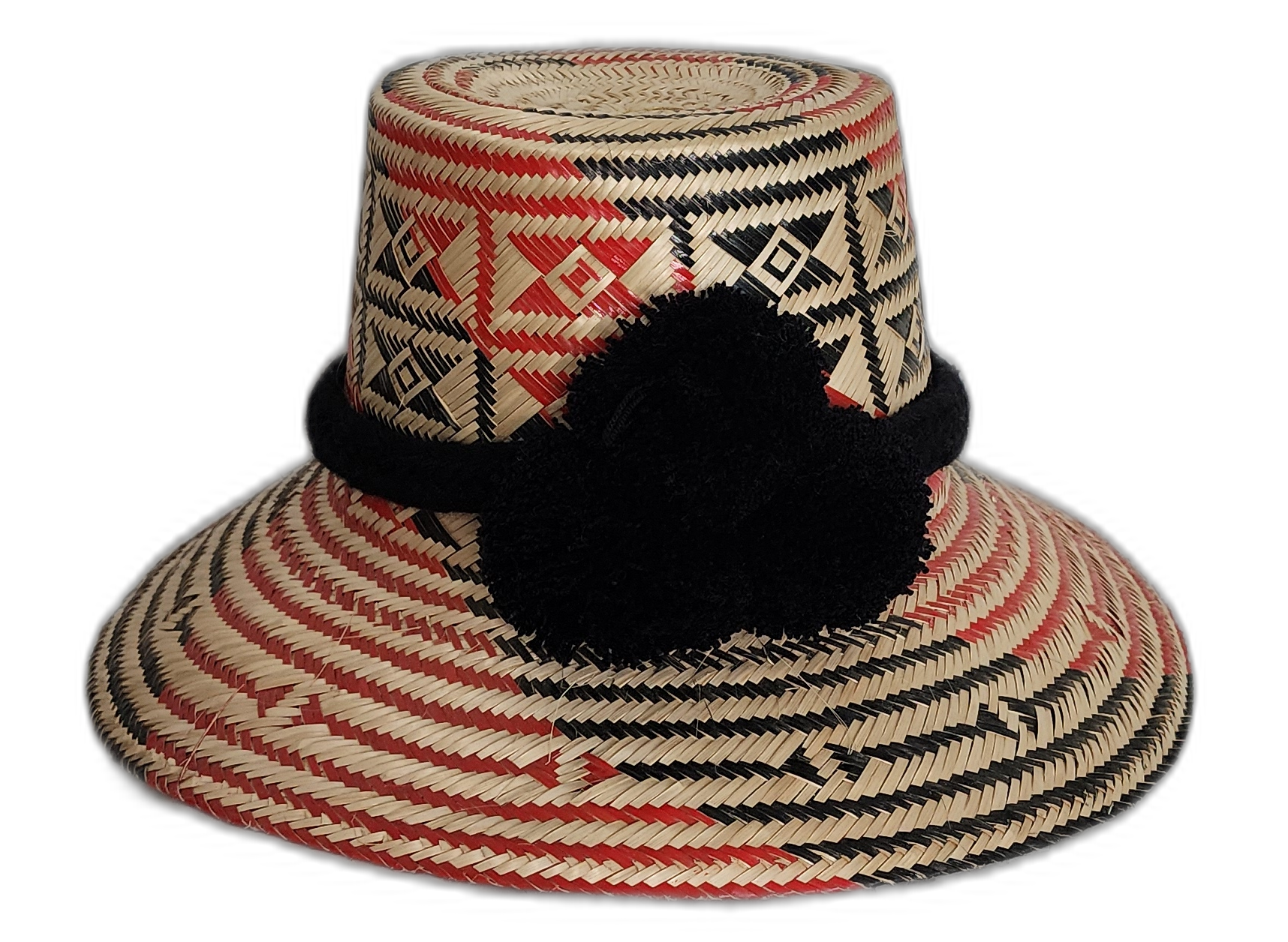 Handmade Wayuu straw hat with red and black geometric weave and black pompoms.Arya handmade Wayuu hat with red and black diamond pattern and black pompoms