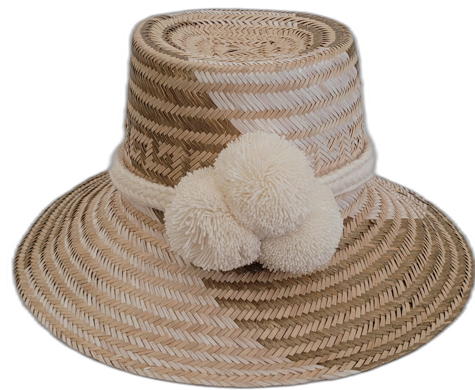 Handmade Wayuu bohemian straw hat with cream pompoms and beige-light brown woven patterns.