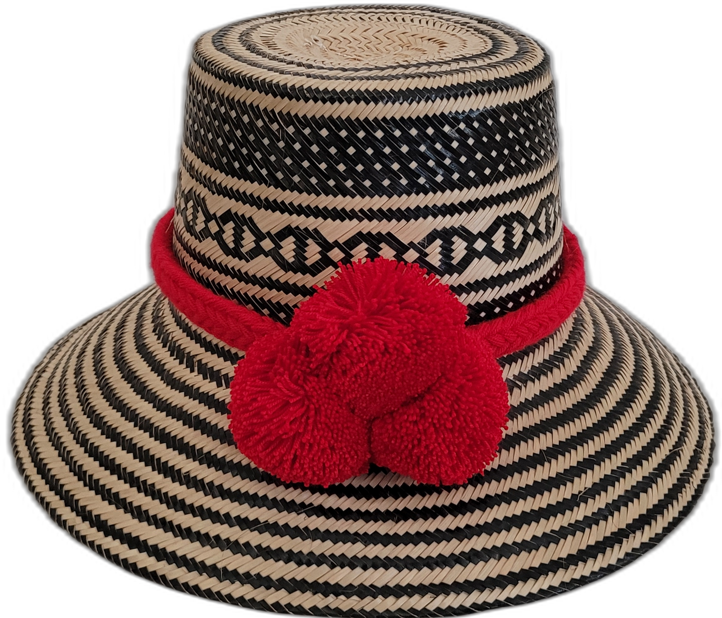 Handmade Wayuu bohemian straw hat with red pompoms and bold black-beige woven patterns.
