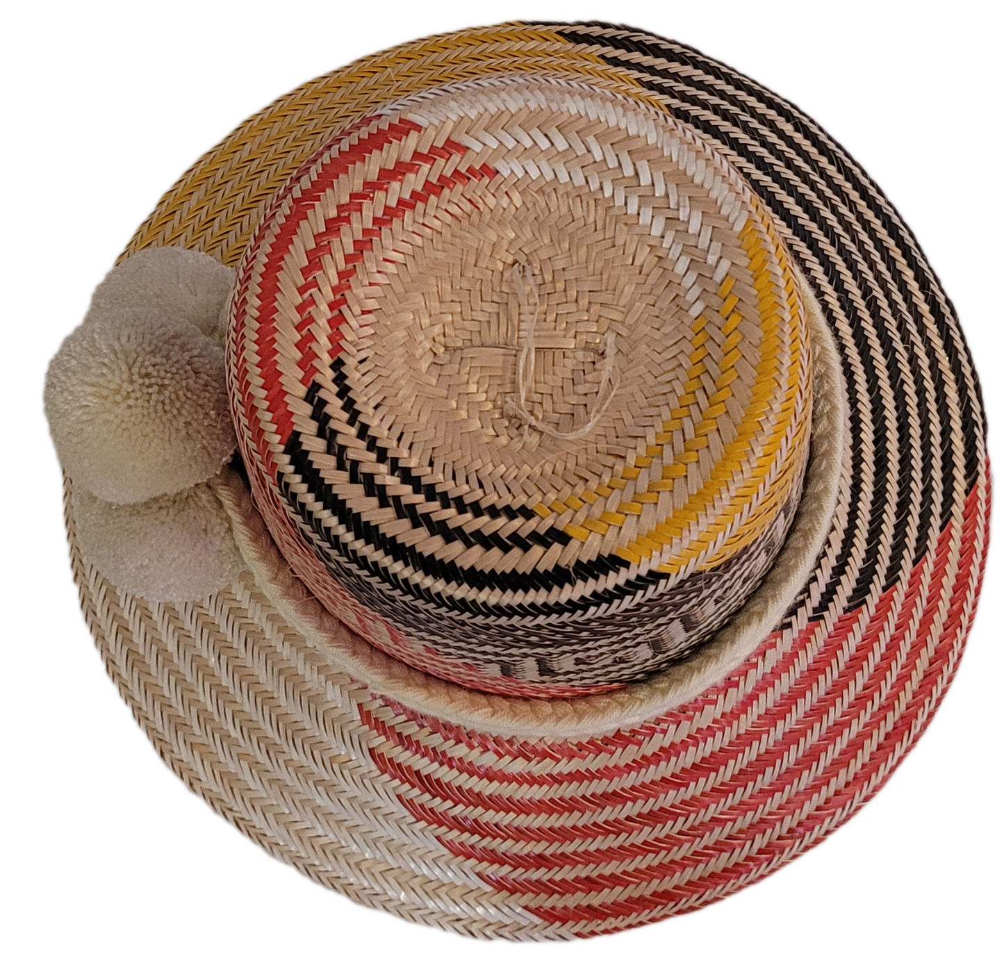 Colorful bohemian straw hat from Wayuu artisans, adorned with a triple white pompom detail.