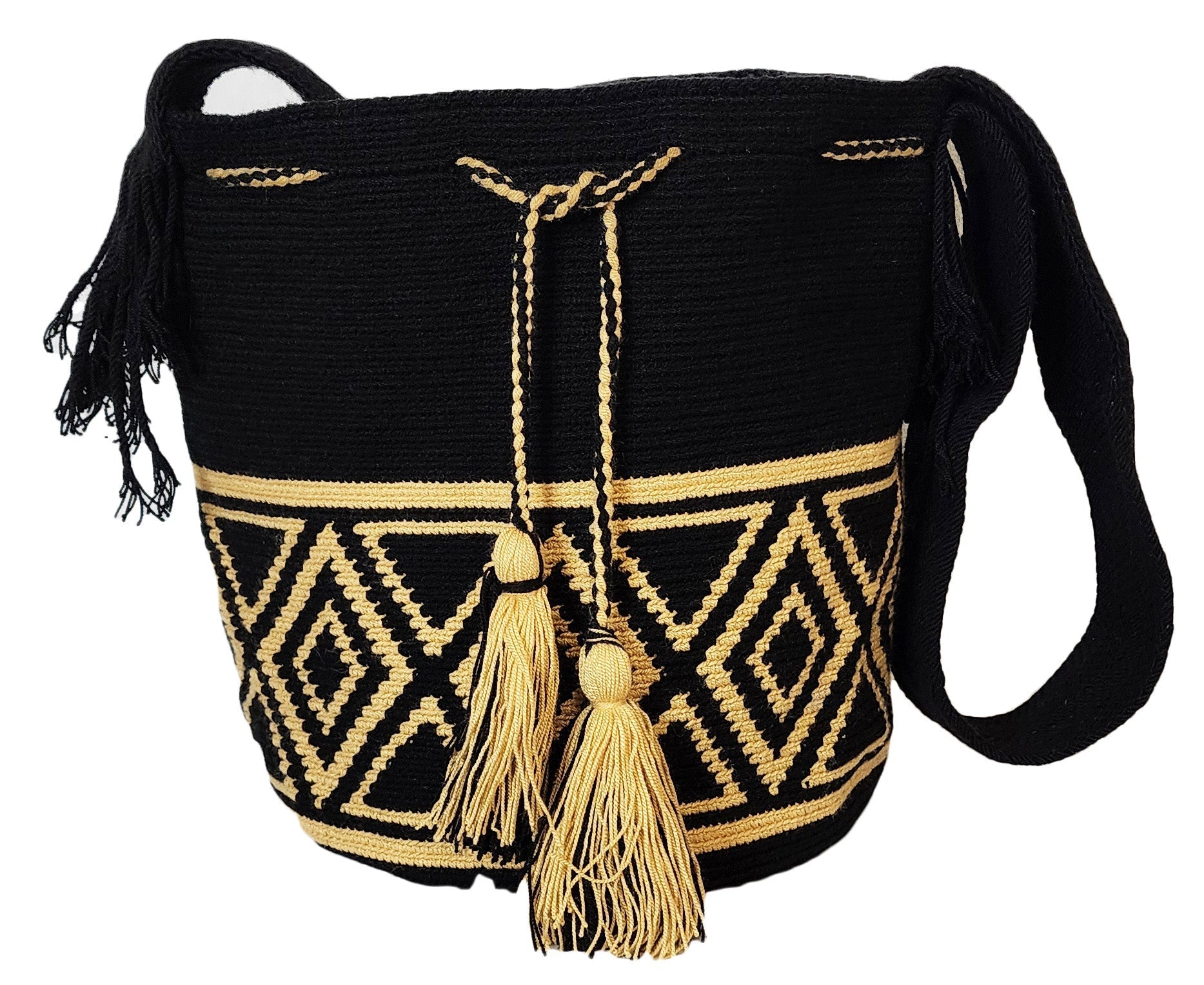 Elegant bohemian crochet bag, handmade by Wayuu artisans, with black body, beige patterns, crossbody strap, and decorative tassels.