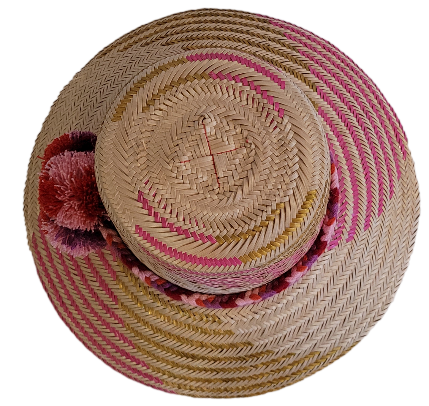 Artisan Wayuu straw hat with pink gold zigzag and soft pompom decor.