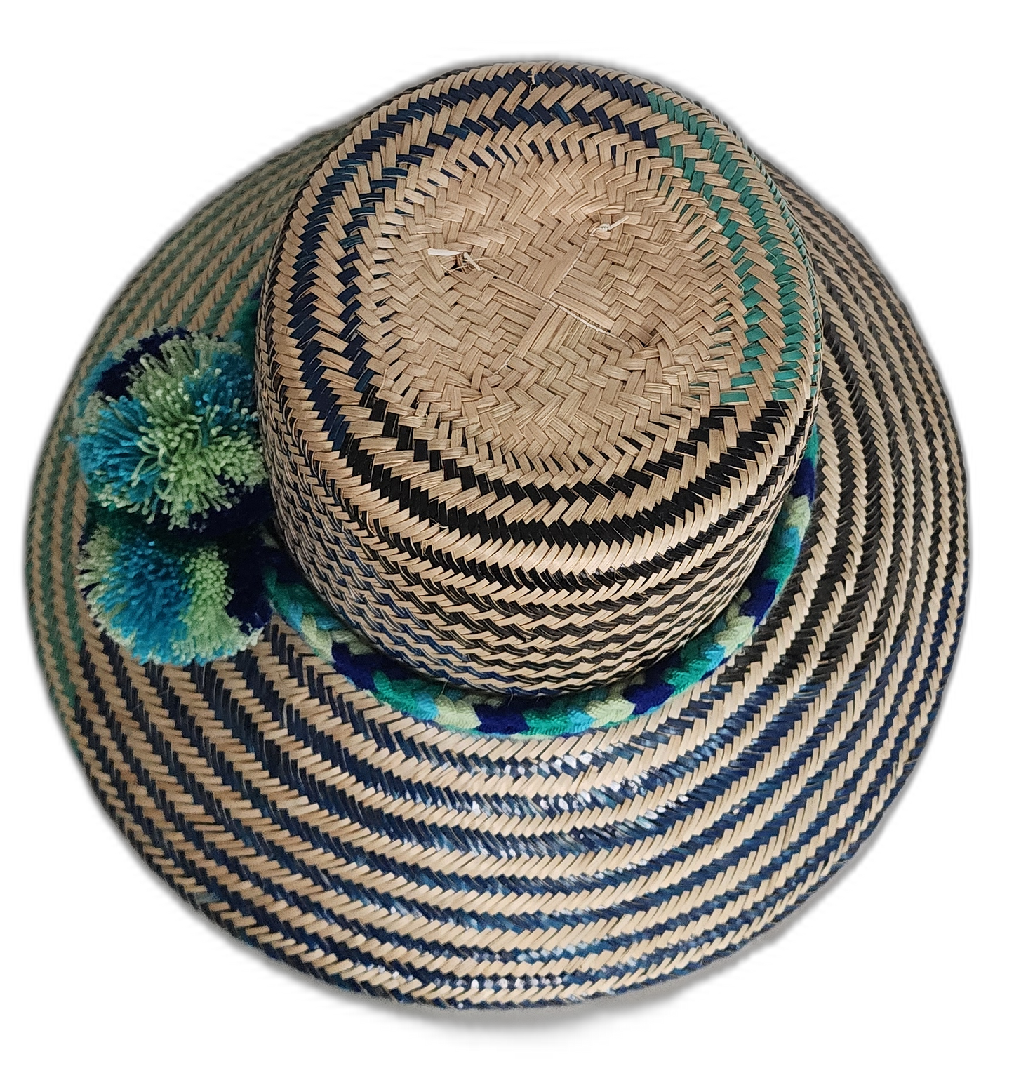 Boho straw hat featuring zigzag weave and decorative pompom band