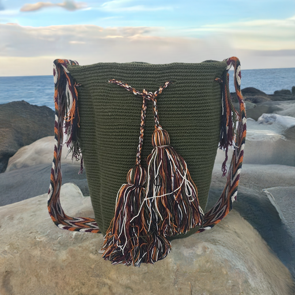 Boho-chic handmade Wayuu crochet bag in olive green with multicolor tassels and a patterned artisan strap — vibrant, earthy, and stylish.