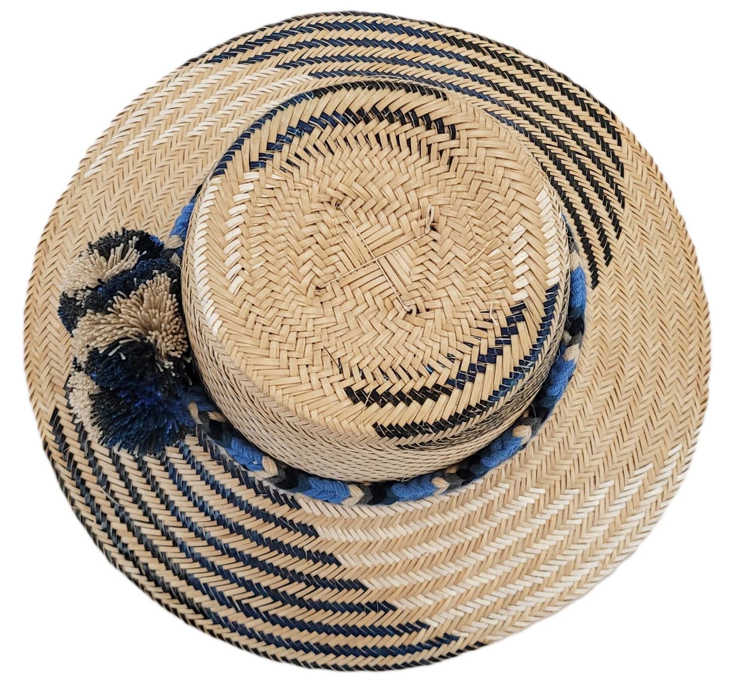 "Colorful artisan Wayuu hat handcrafted from Iraca palm fibers, adorned with symbolic pompoms, showcasing adjustable styles f