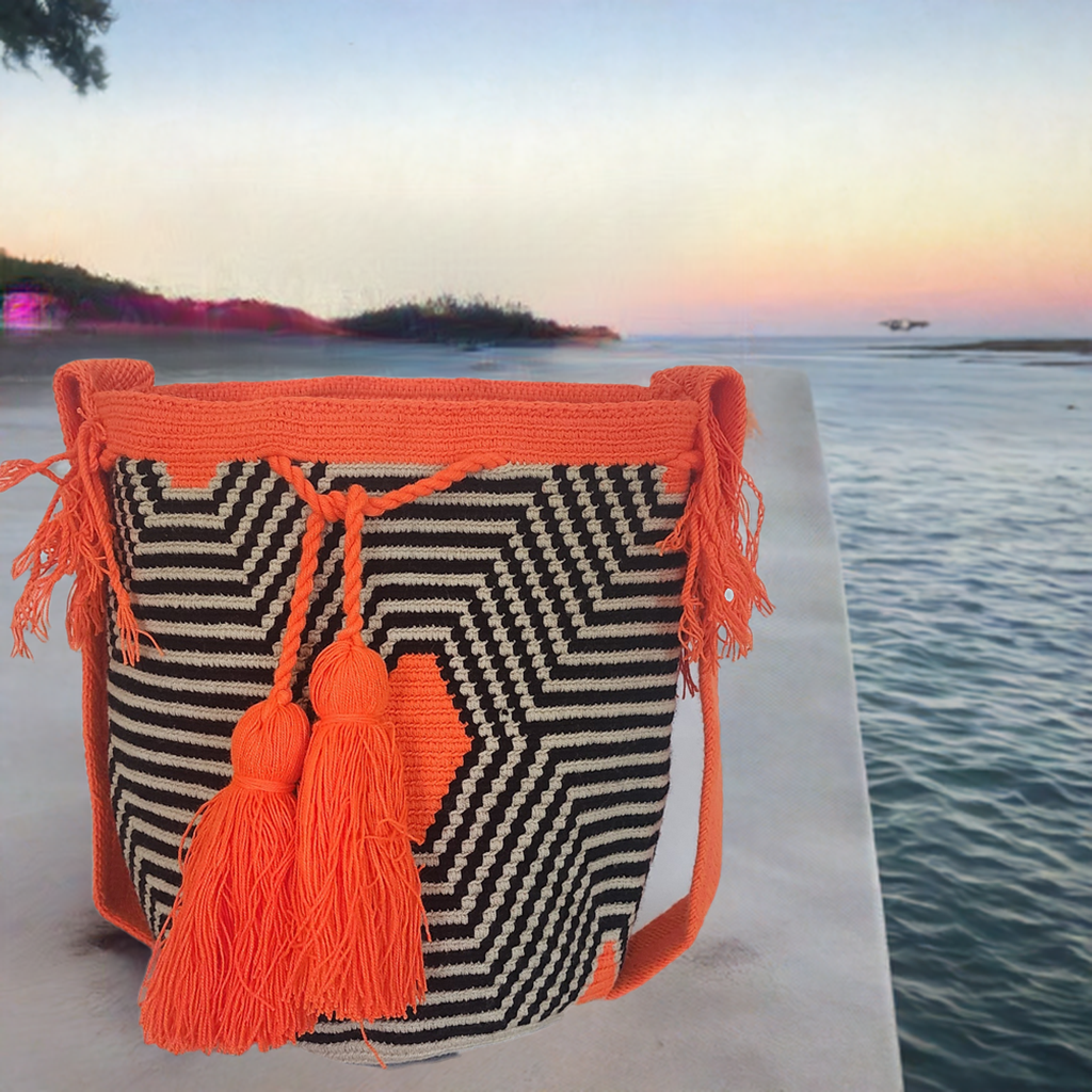 "Colorful handmade Wayuu crochet bag with geometric patterns, adjustable woven strap, ideal for versatile bohemian style."