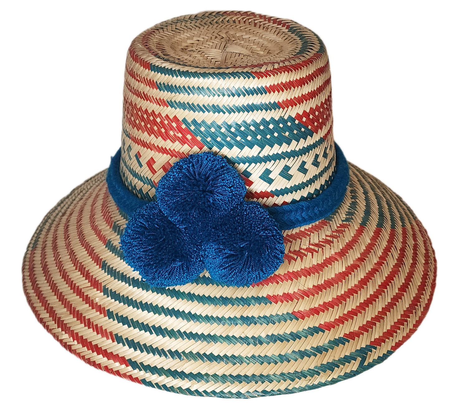 "Colorful handmade Wayuu hat by Wuitusu, crafted from Iraca palm fibers with unique pompoms, offering flexible wear styles."