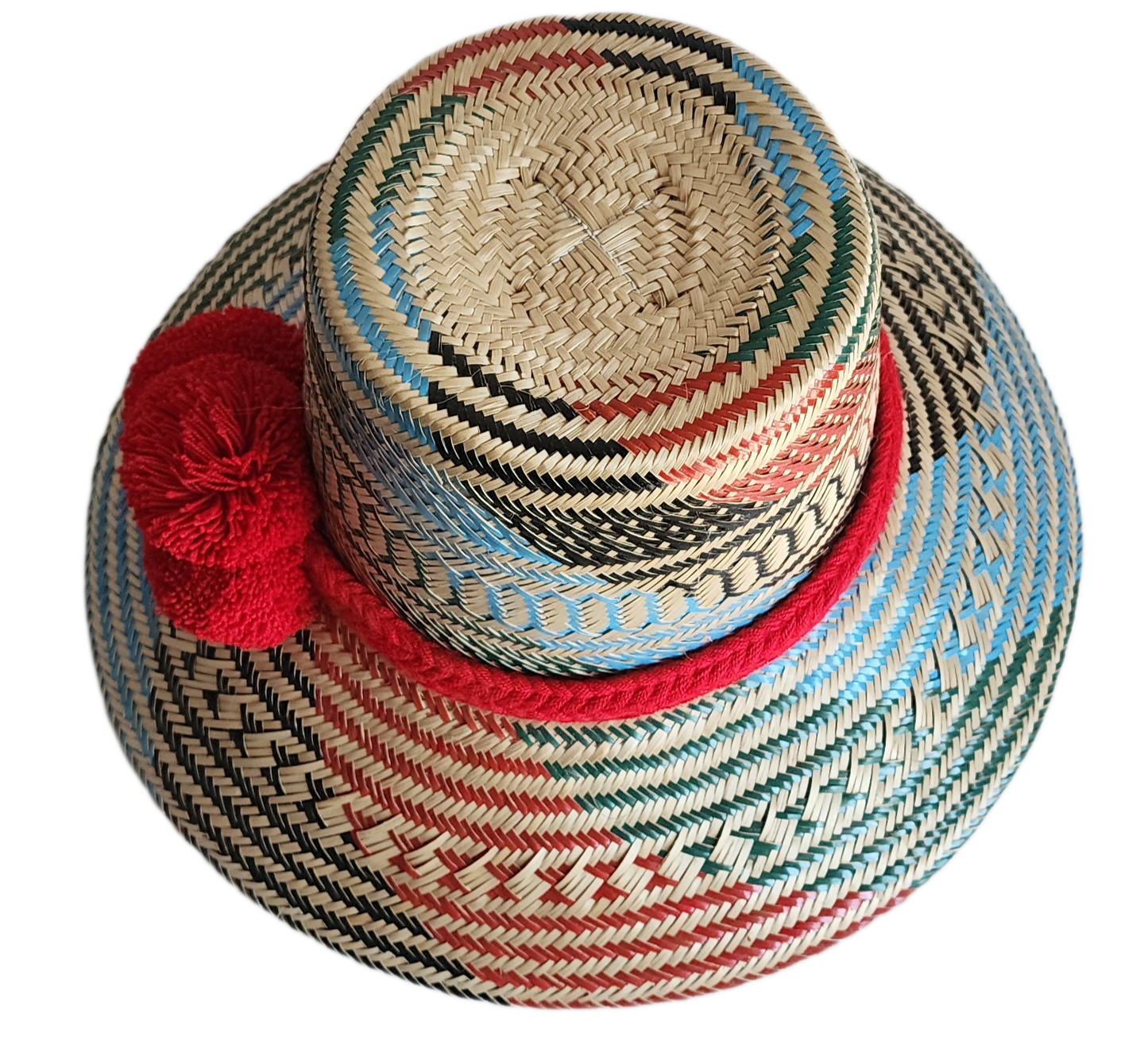 "Colorful handmade Wayuu hat crafted from Iraca palm fibers, adorned with significant pompoms, and adjustable for a perfect f