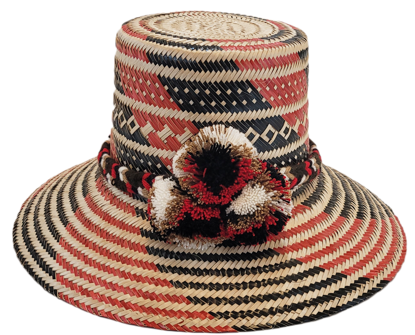 "Colorful handmade Wayuu hat crafted from Iraca palm fibers, featuring culturally significant pompoms for stylish sun protect