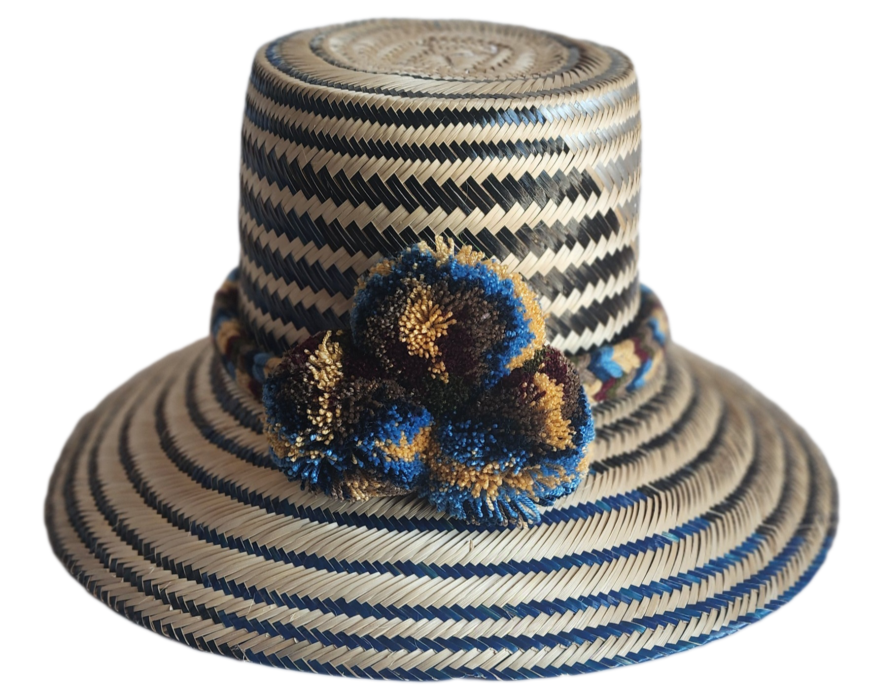 "Colorful handmade Wayuu hat from Colombia and Venezuela, woven from Iraca palm fibers with cultural pompoms."