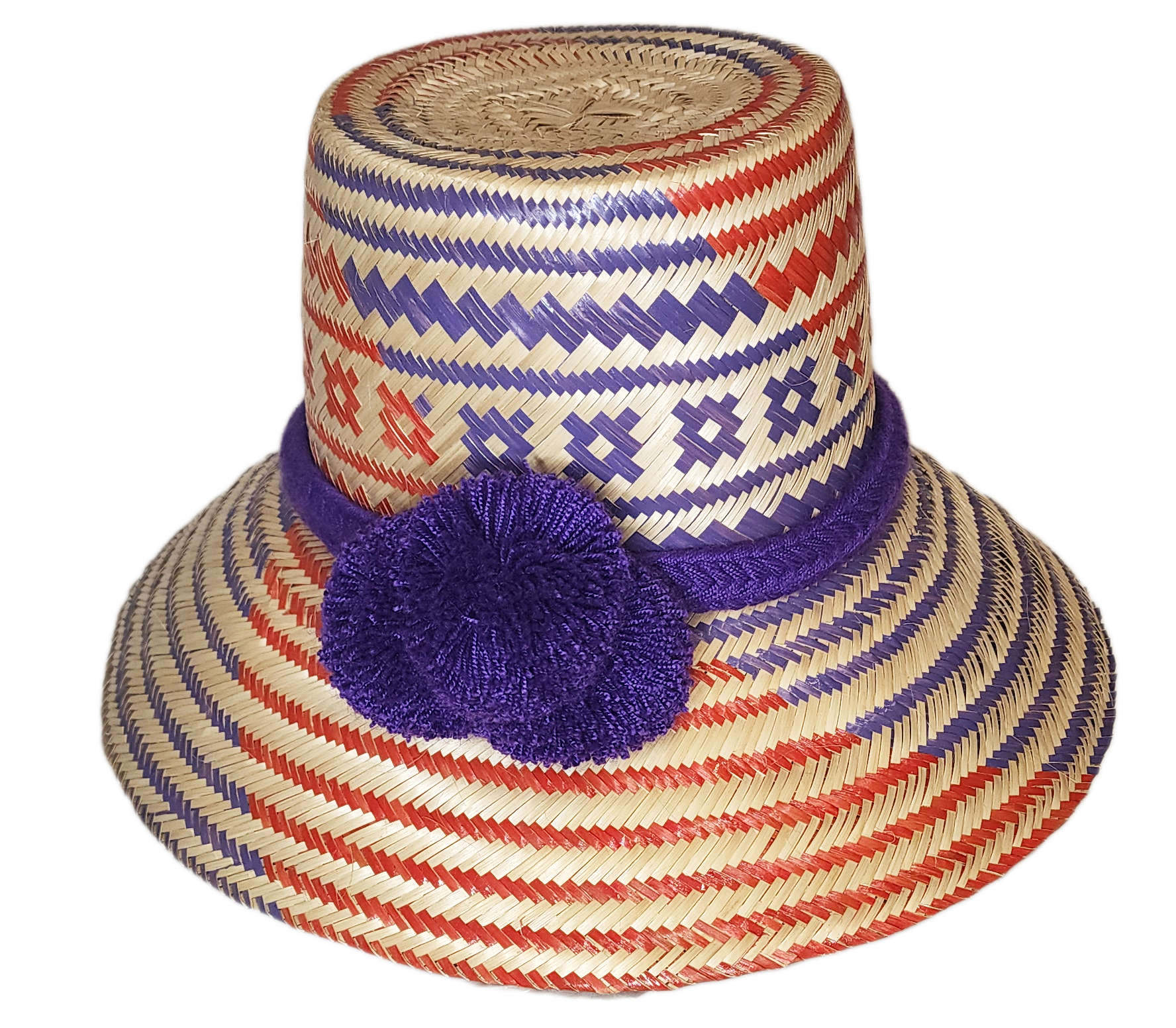 Handmade Wayuu straw hat with bold purple pompoms and red and purple stripes