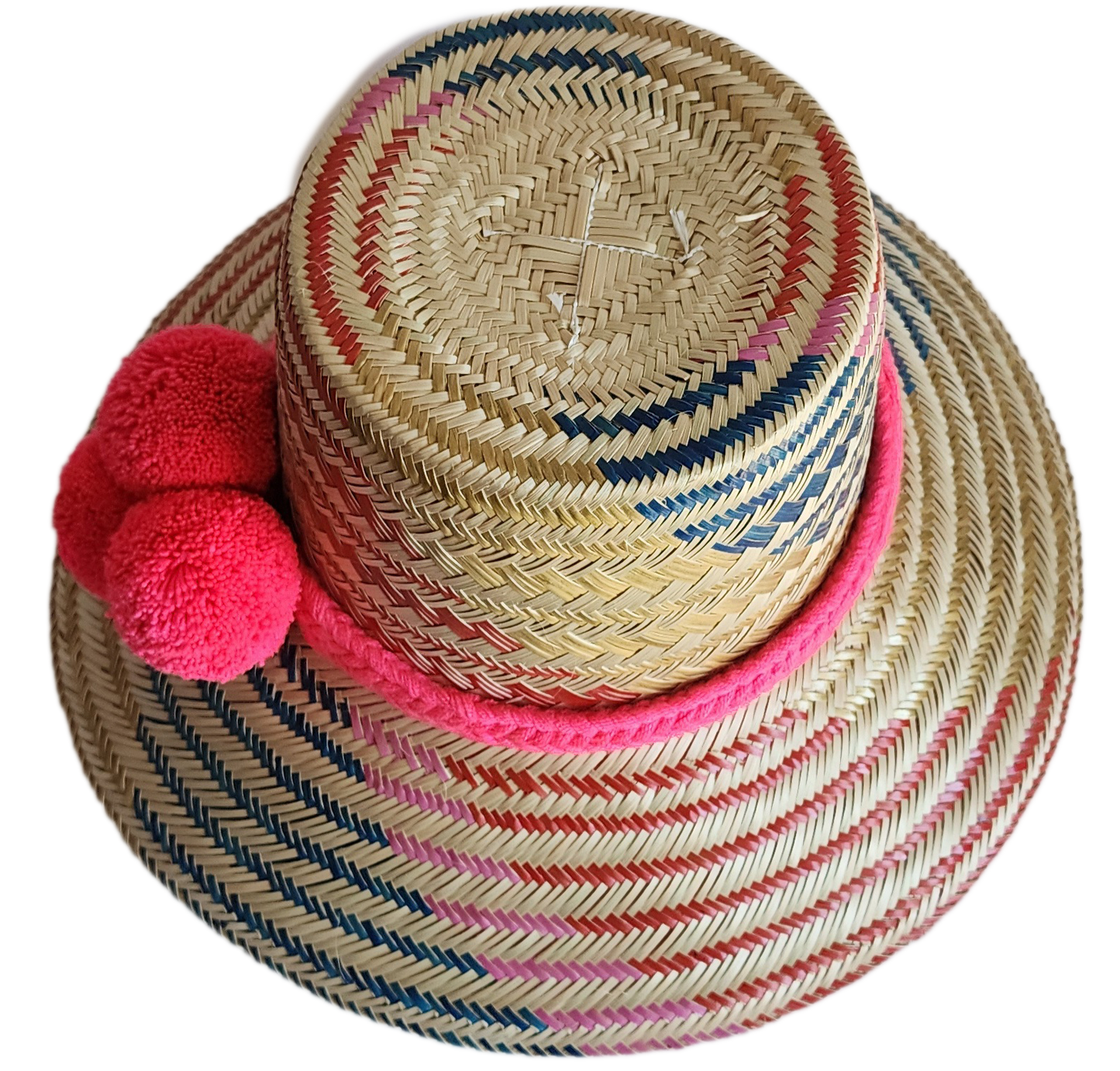 "Colorful handmade Wayuu hat from Iraca palm fibers, adorned with culturally significant pompoms, showcasing unique weaving b