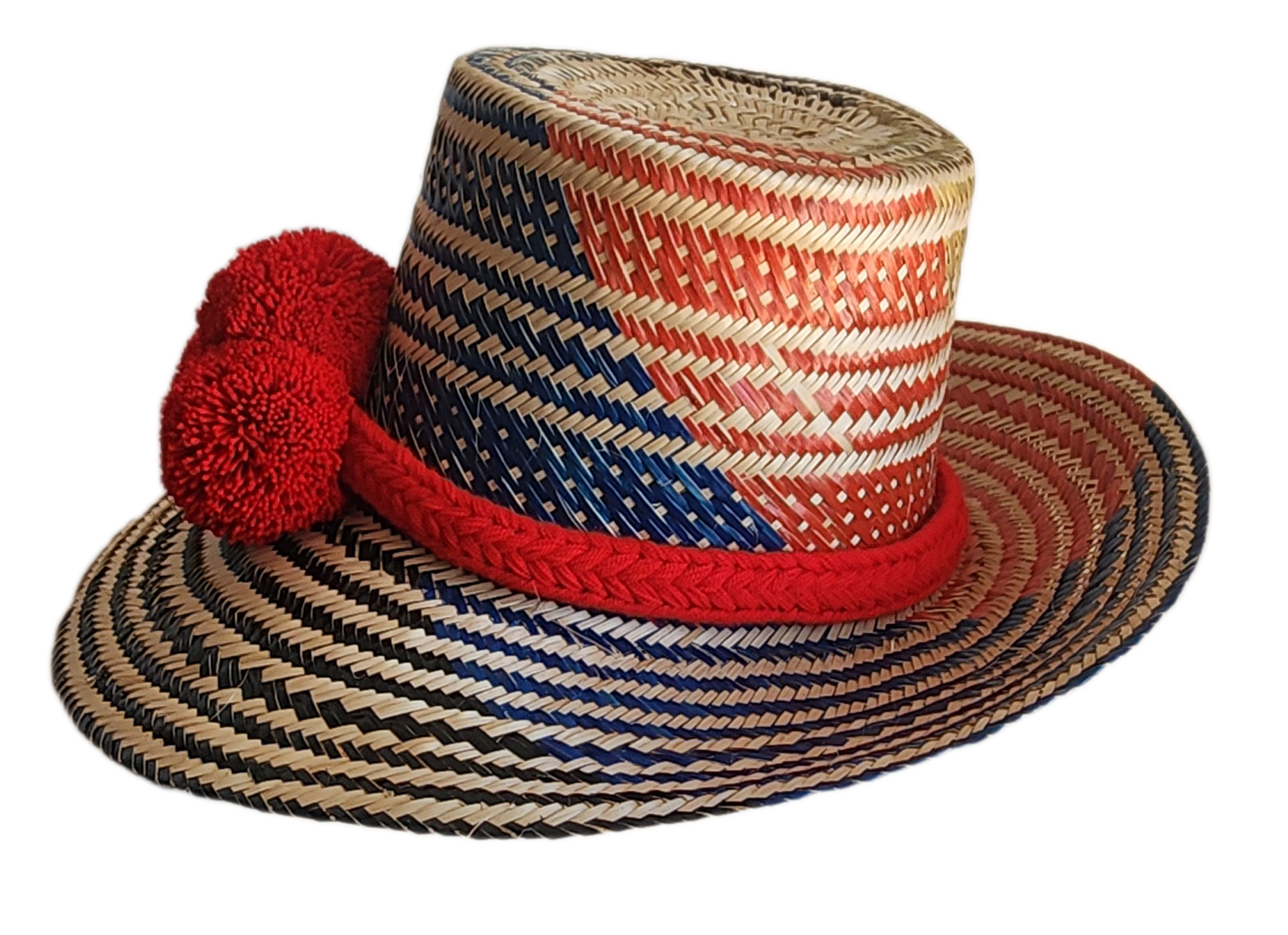 "Colorful handmade Wayuu hat woven from Iraca palm fibers, adorned with significant pompoms, adjustable for various sizes."