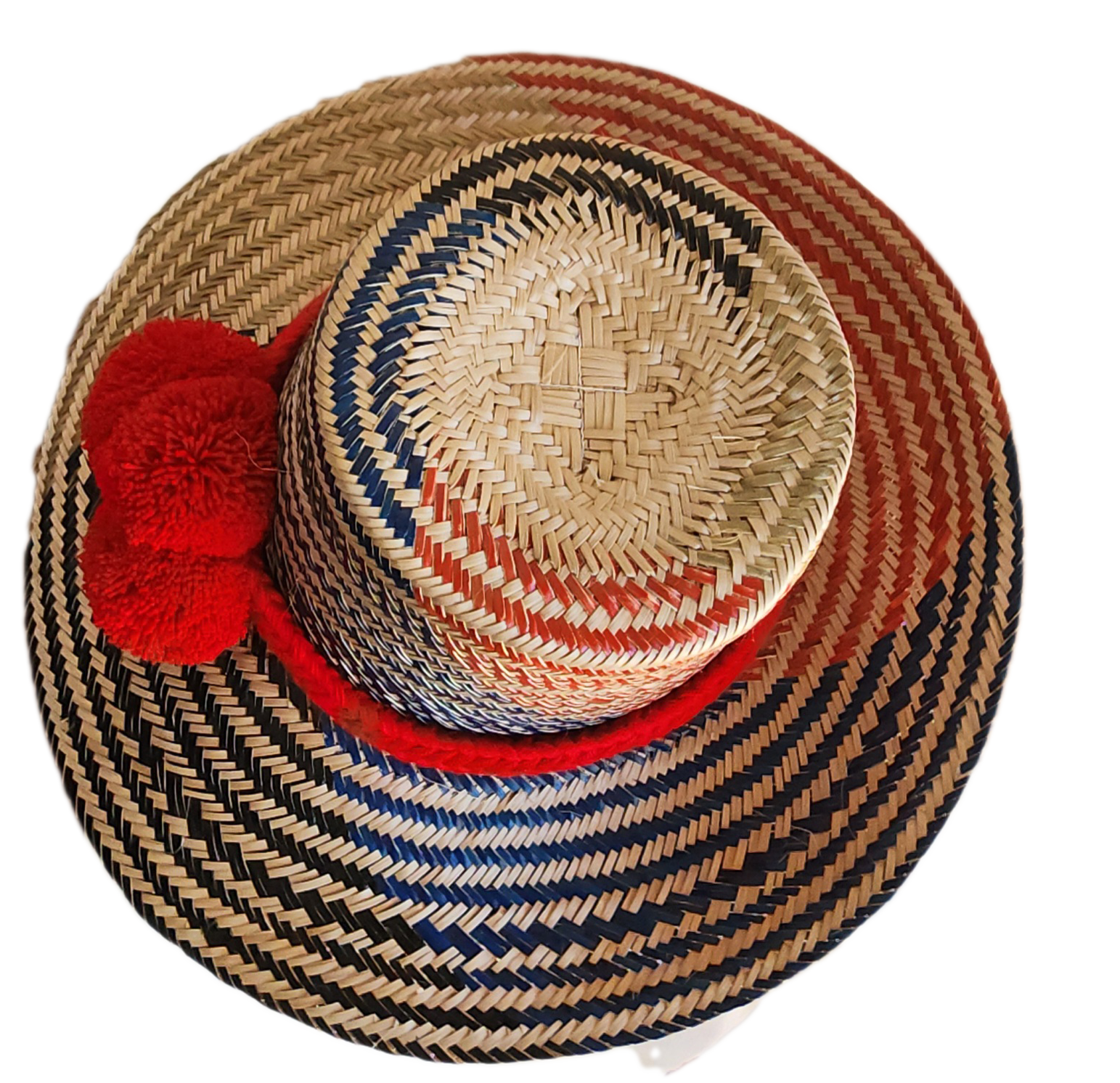 "Colorful handmade Wayuu hat woven from Iraca palm fibers, adorned with significant pompoms, adjustable for various sizes."