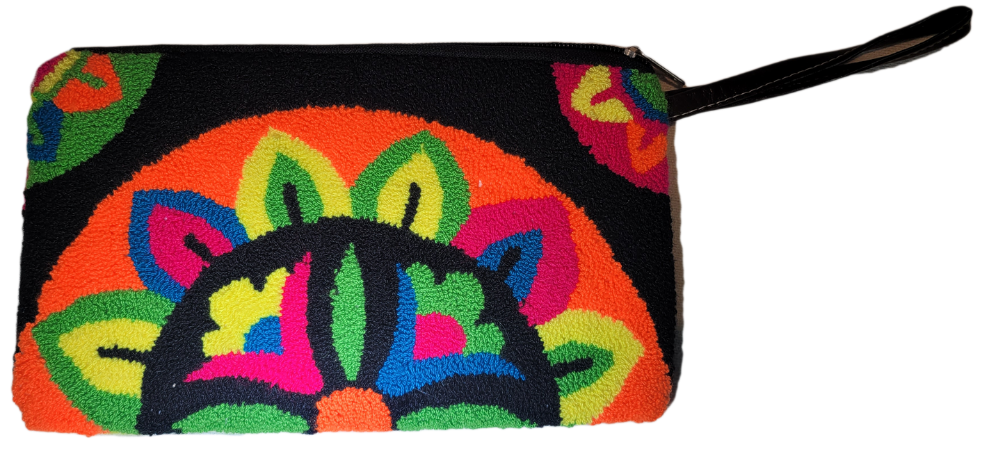 "Colorful handmade Wuitusu Needle Punch Clutch by Wayuu artisans, featuring vibrant patterns and a zip closure."