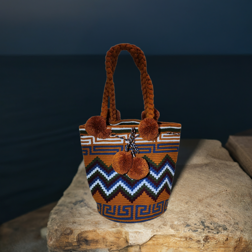 "Colorful handmade Wuitusu Wayuu crochet bag with short handle, displaying unique patterns and artisan craftsmanship."