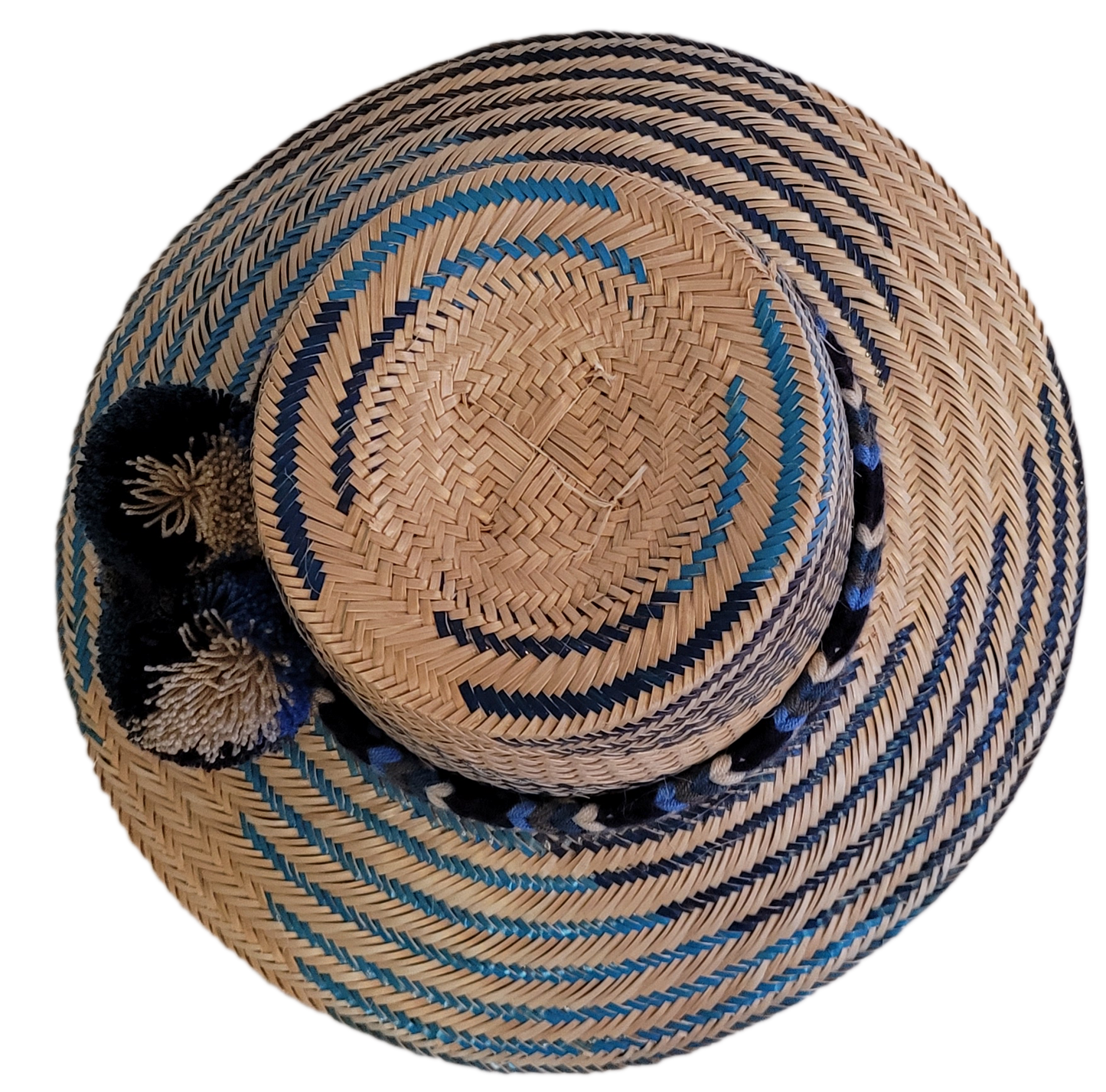 Stylish handmade boho hat with bold navy pompoms and colorful blue tones.