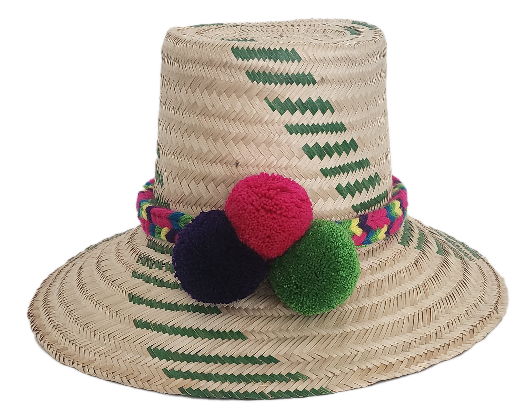 Handwoven Wayuu straw hat with green chevron patterns and a vibrant braided band, finished with red, green, and purple pom-poms. A playful boho accessory.