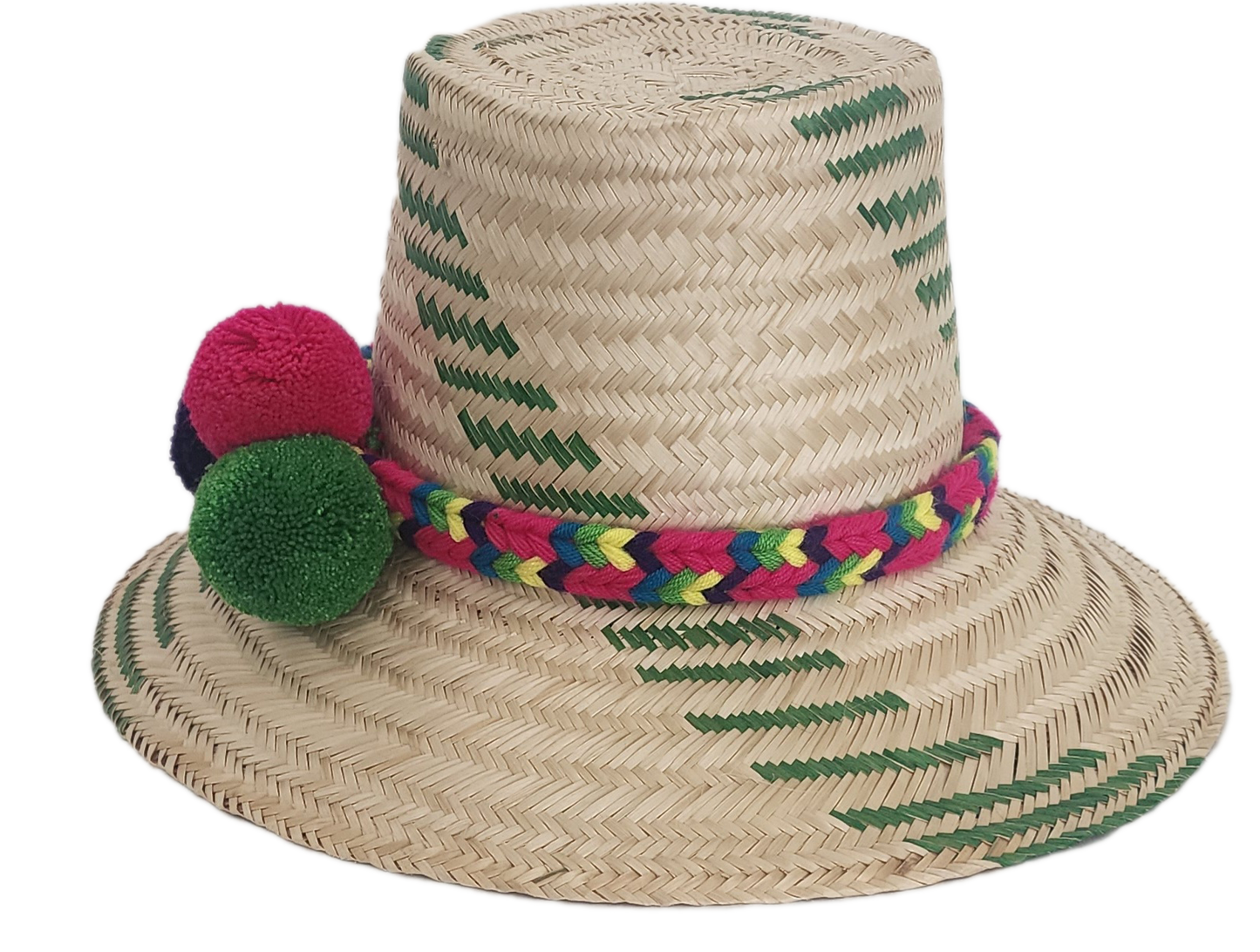 Handwoven Wayuu straw hat with green chevron patterns and a vibrant braided band, finished with red, green, and purple pom-poms. A playful boho accessory.