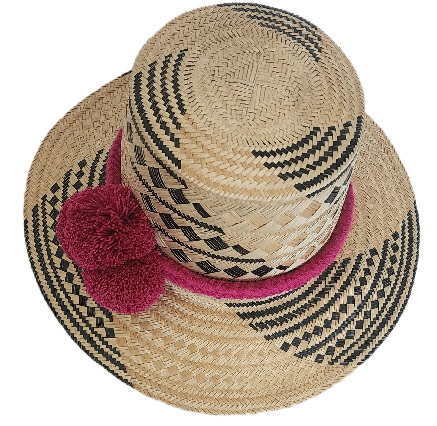 Traditional Wayuu straw hat with magenta details and bold black pattern — colorful and bohemian.