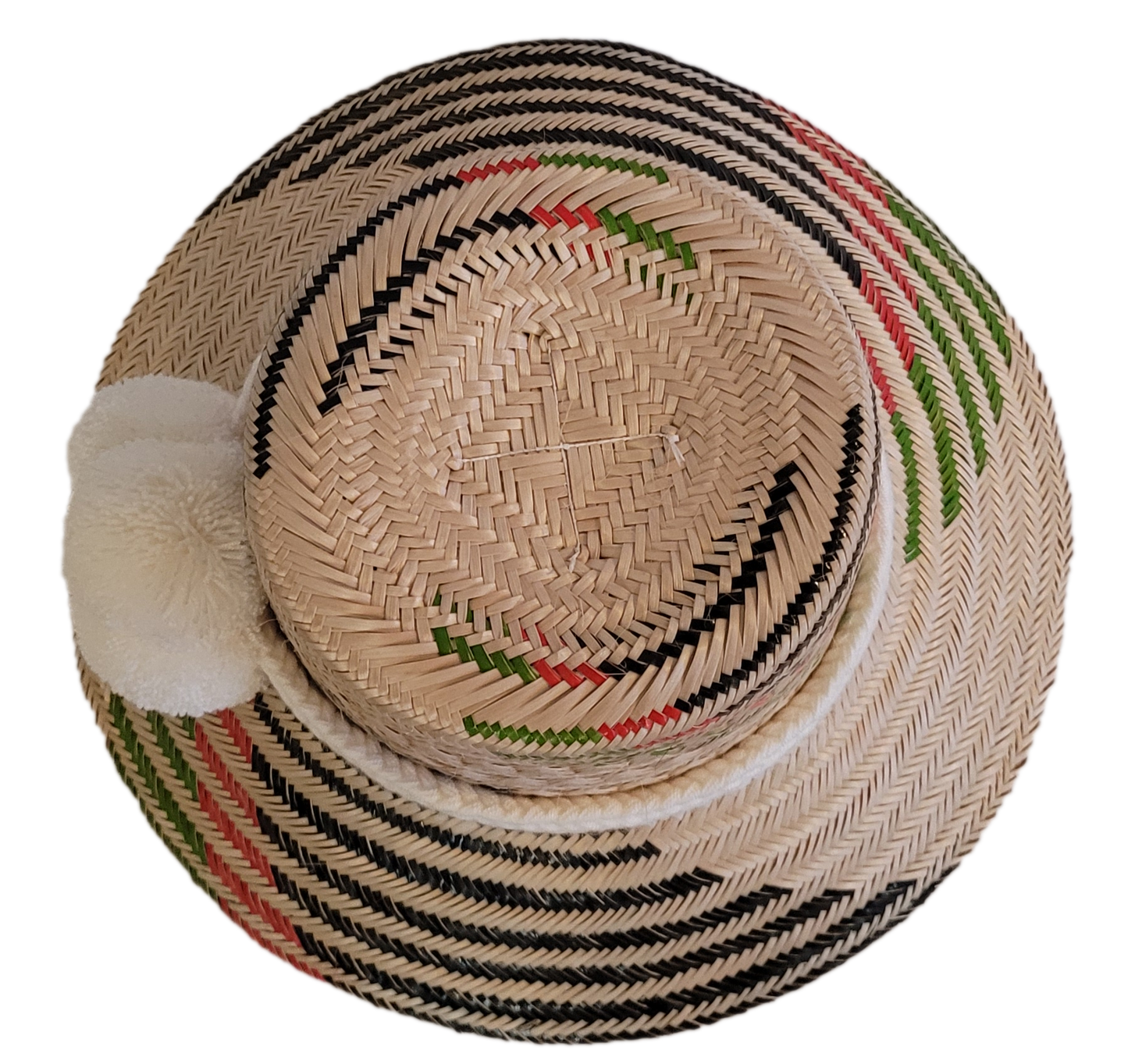Unique handmade straw hat from Wayuu artisans, featuring bold black patterns and white pom accent.
