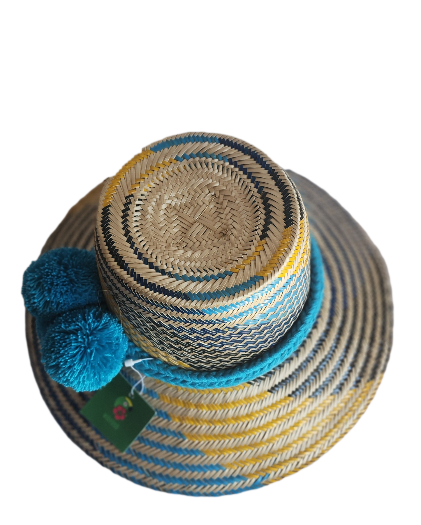"Handmade colorful Wayuu hat from Iraca palm fibers with decorative pompoms, crafted by Colombian and Venezuelan artisans."