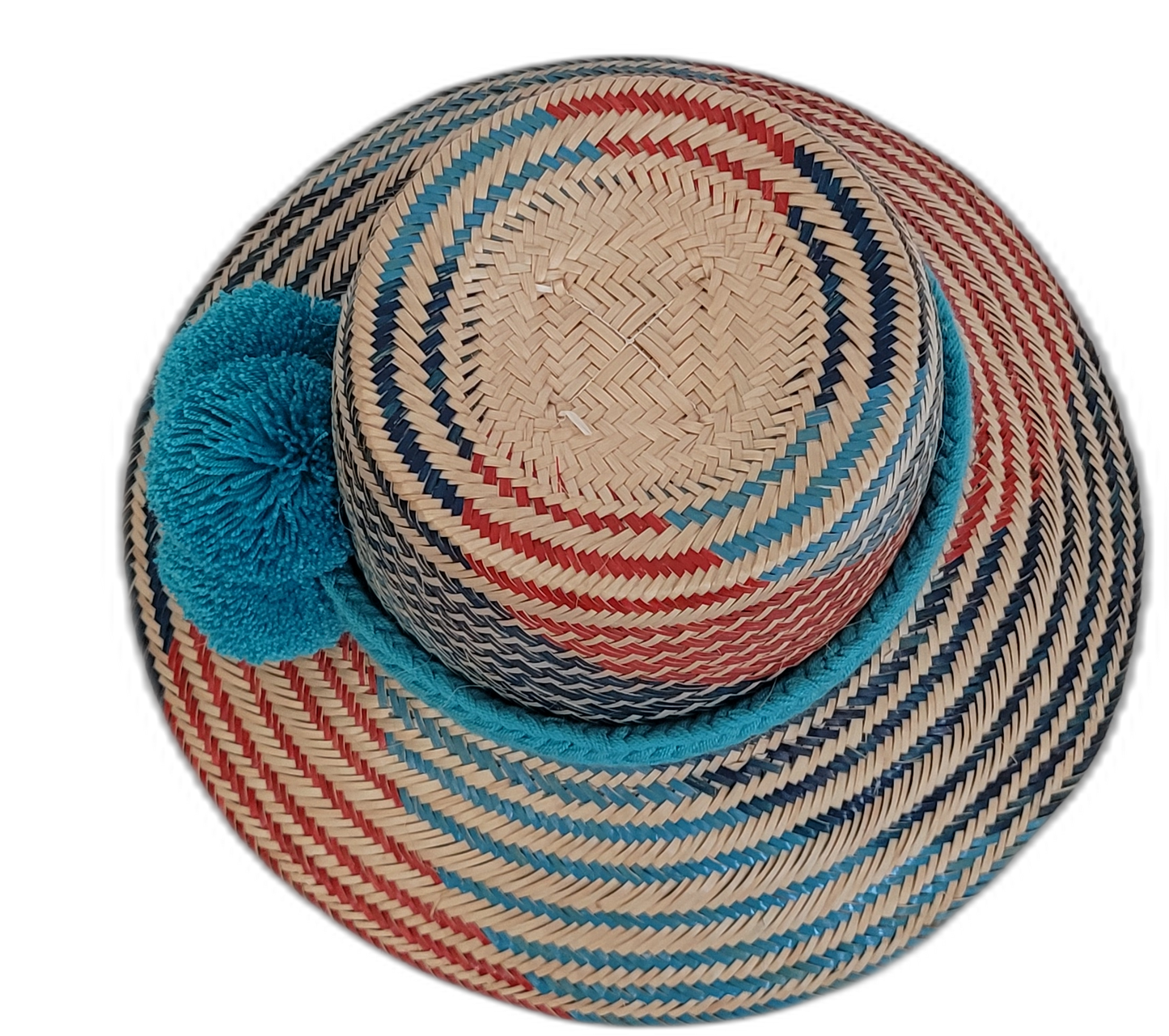 Artisan Wayuu hat, a handmade bohemian straw hat with colorful design and large decorative pompoms.