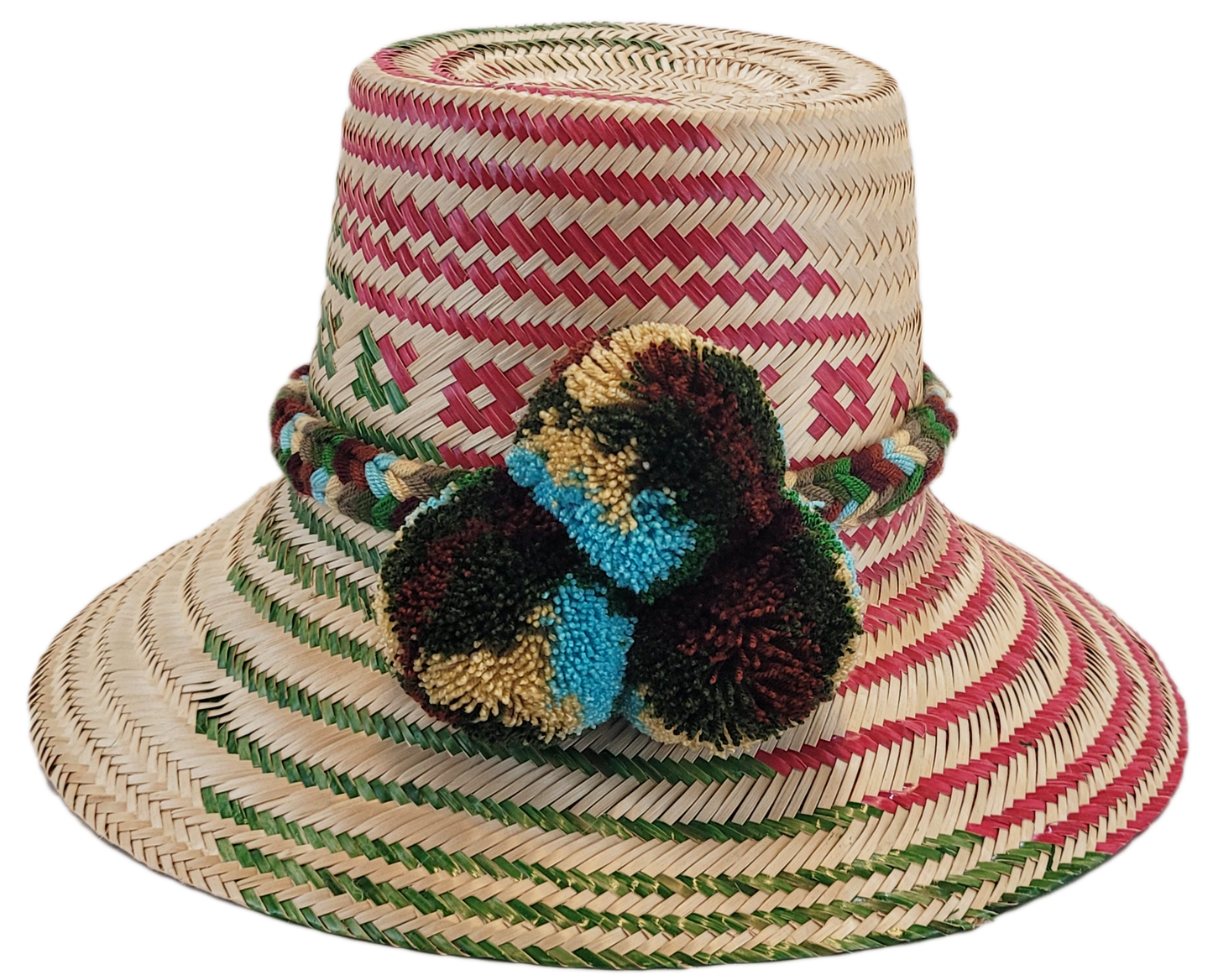 "Handmade Wayuu hat crafted from Iraca palm fibers with colorful pompoms, representing the Wayuu tribe's heritage."
