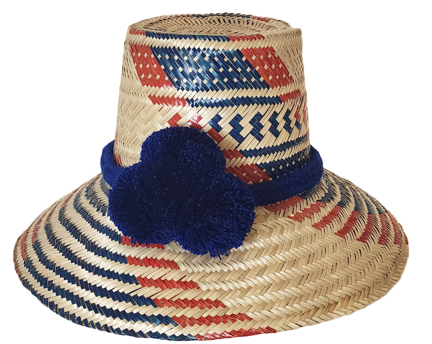 "Handmade Wayuu hat woven from Iraca palm fibers, decorated with colorful pompoms, symbolizing cultural heritage and prosperi