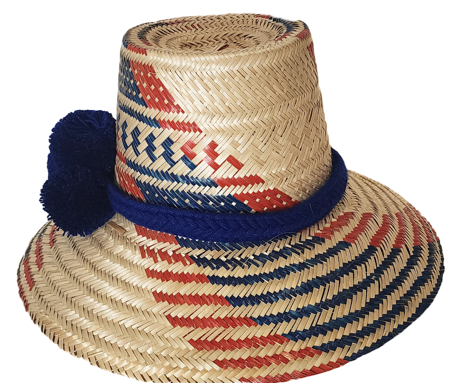 "Handmade Wayuu hat woven from Iraca palm fibers, decorated with colorful pompoms, symbolizing cultural heritage and prosperi
