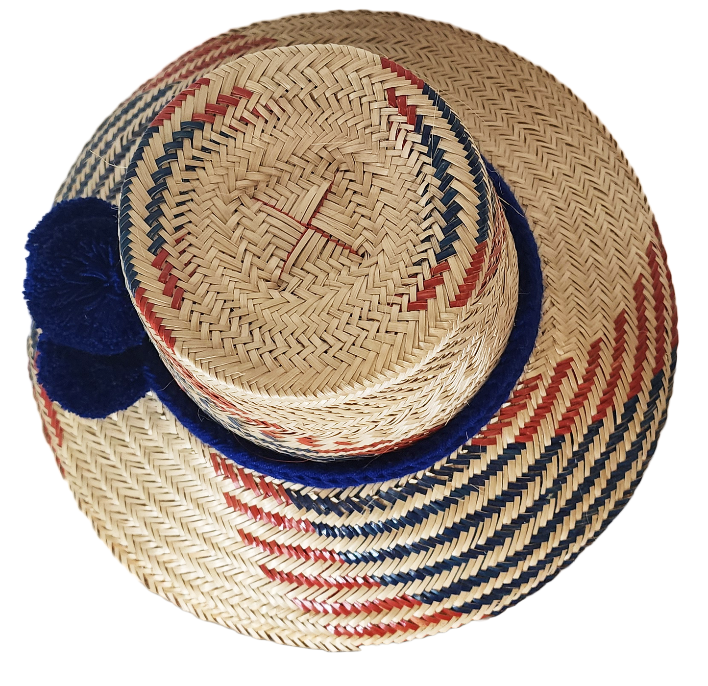 "Handmade Wayuu hat woven from Iraca palm fibers, decorated with colorful pompoms, symbolizing cultural heritage and prosperi