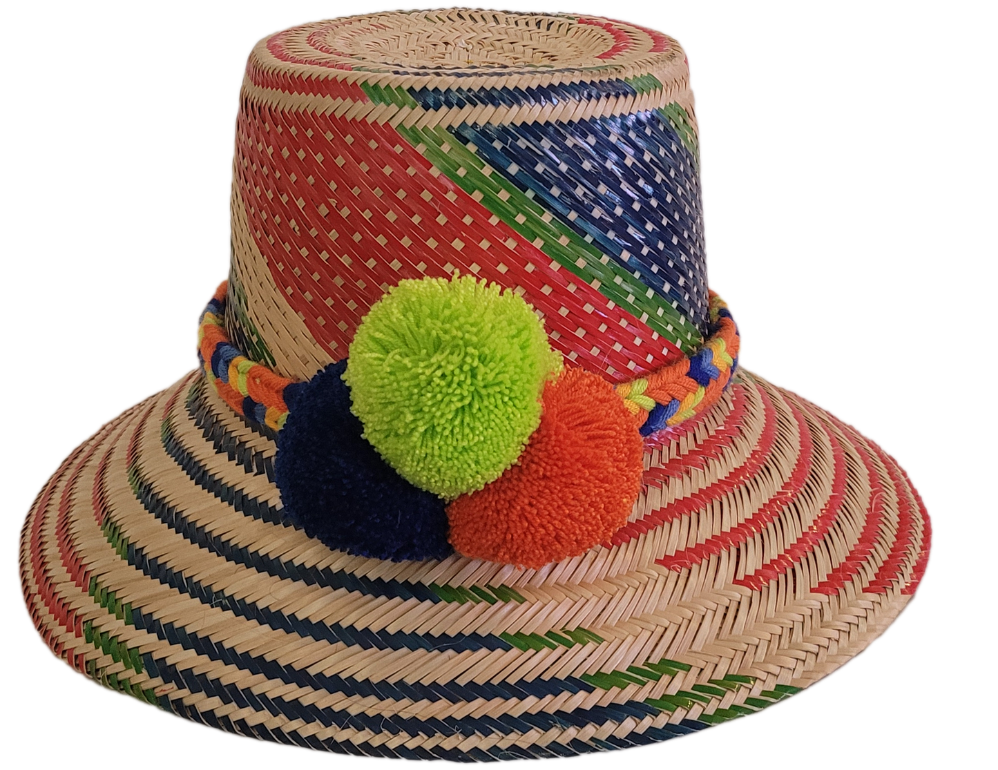 Colorful handmade Wayuu straw hat with red, green, and blue patterns, finished with neon green, orange, and navy pompoms — a bold boho artisan piece.