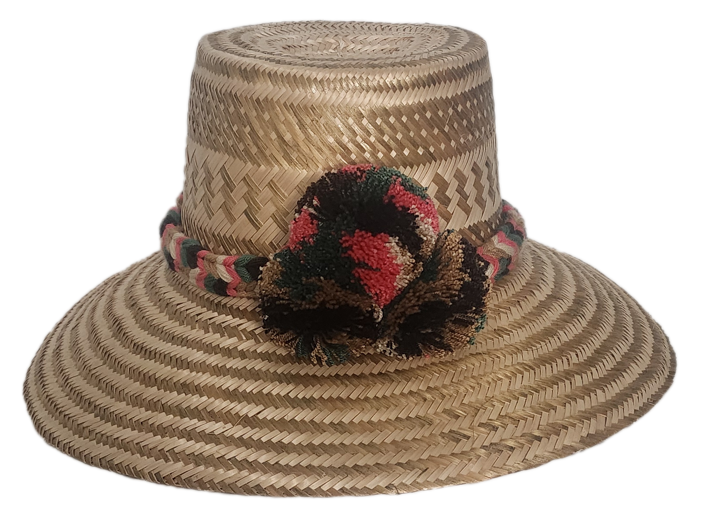 Handmade boho straw hat crafted by Wayuu artisans using natural Iraca palm, featuring an earth-tone braided band and multicolor pom-pom detail. Lightweight and perfect for summer style.