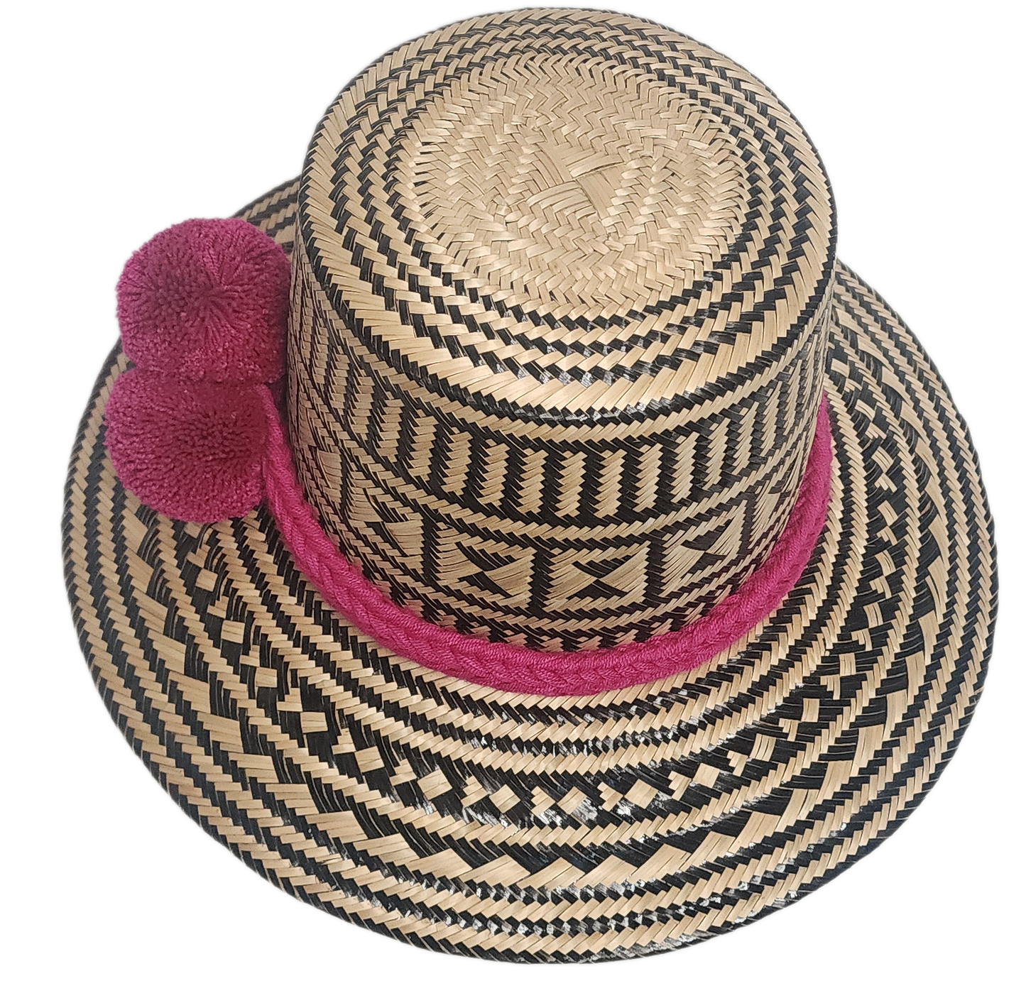 Bohemian-style handmade straw hat for women with black and natural weave, finished with a colorful pink band and statement pom-poms.