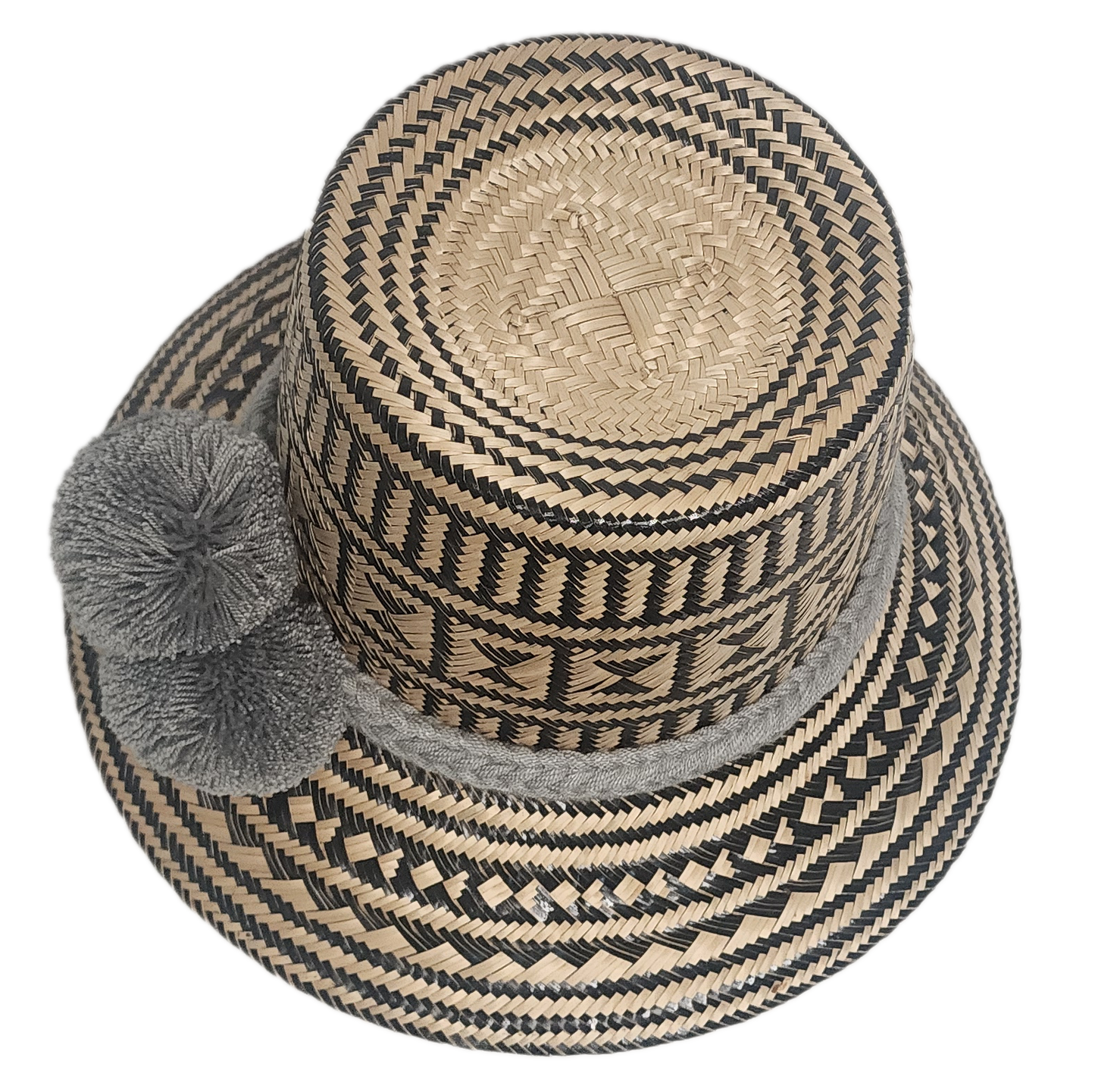 Natural and black woven Wayuu hat with three grey handmade pom-poms and a thick grey band — perfect for sun protection and boho fashion styling.