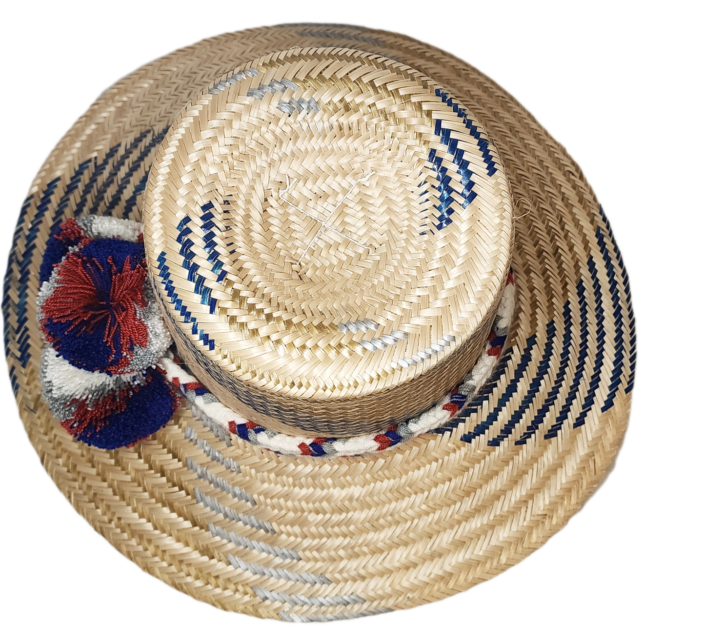 "Handwoven Wayuu hat made from Iraca palm fibers, adorned with colorful pompoms, showcasing artisan craftsmanship and cultura